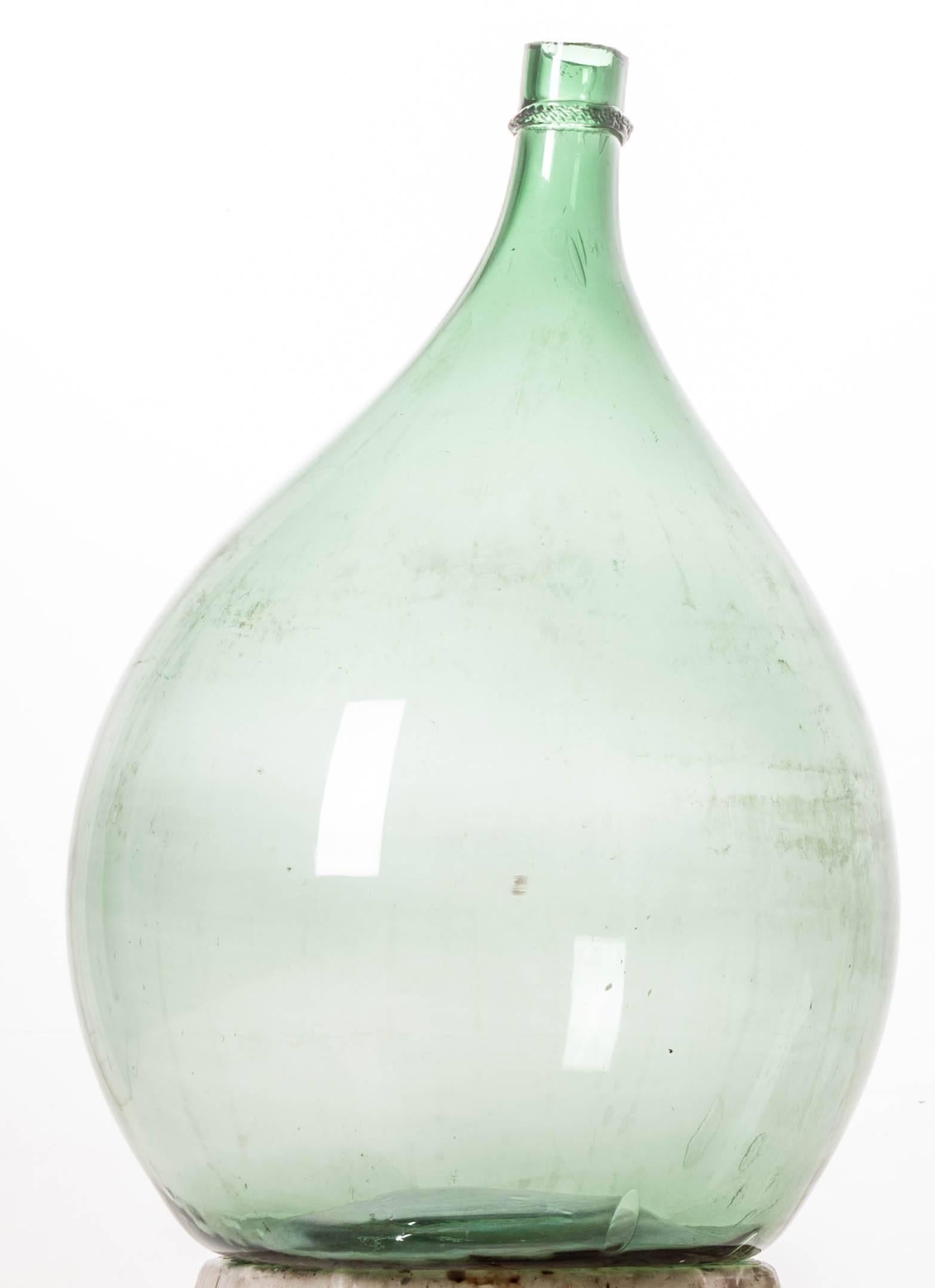 This large, green wine keg, or demijohn as they are sometimes called, remains fully intact after almost 150 years. Still in wonderful condition, this piece would be a wonderful addition to your space, giving it an element of texture and color. Made
