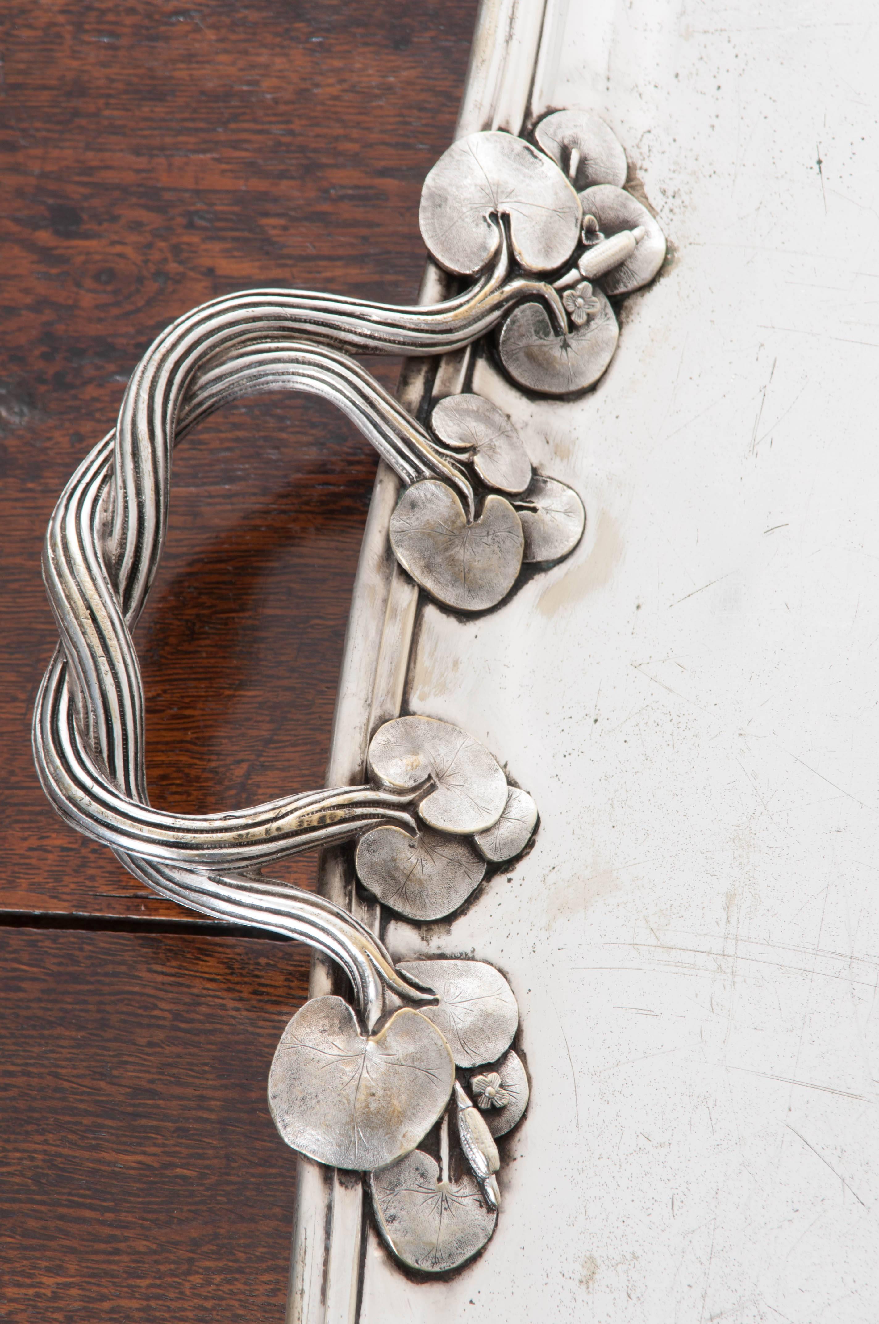 Etched into the lower right corner of this silver serving tray is a nautical flag bearing two crossed anchors. This flag was the seal for the entire yacht for which this tray was made, and would be found on all dinnerware and serving pieces. Twisted