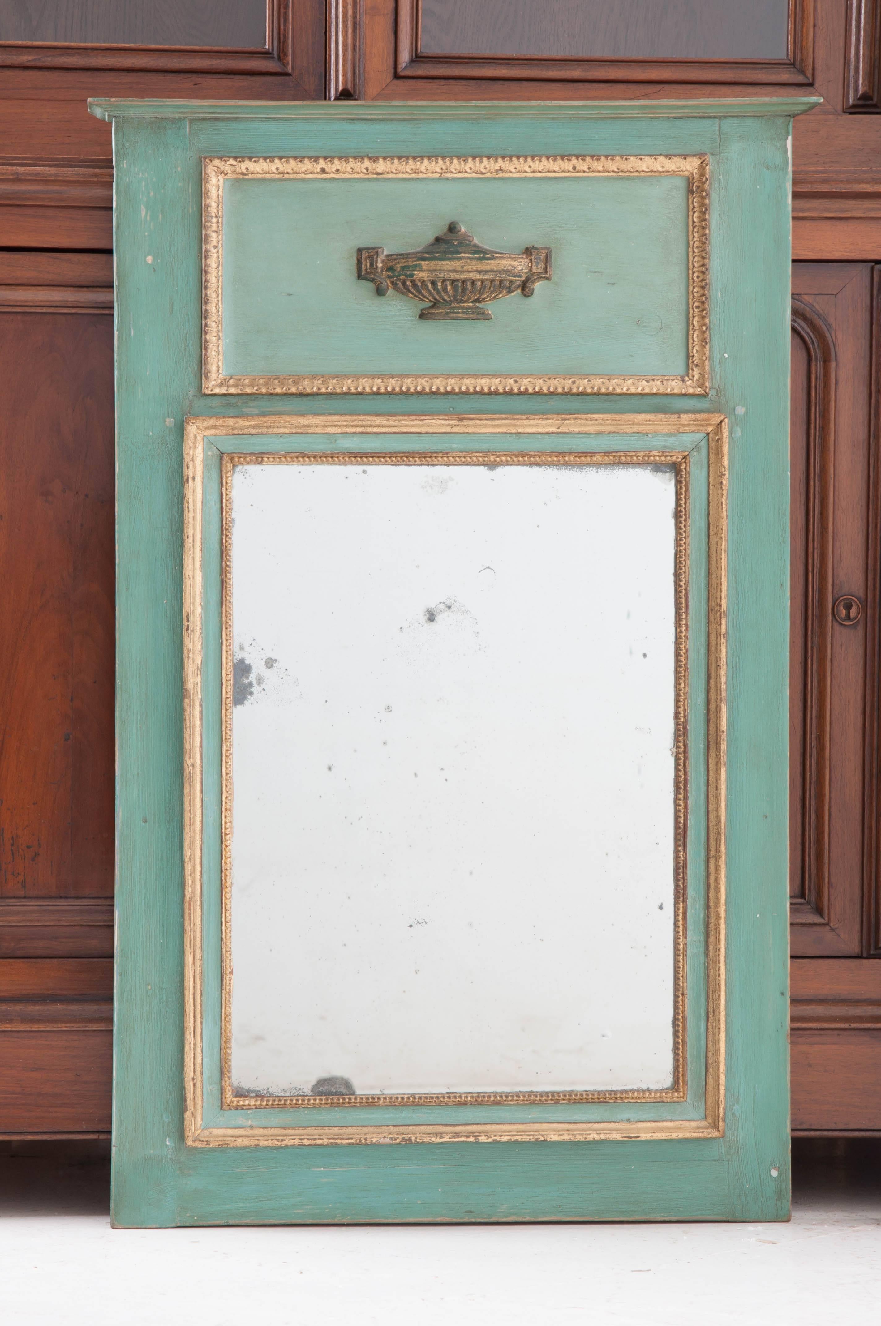 A darling petite trumeau from 19th century, France. Painted turquoise and sporting fine gold gilt trim, this smaller trumeau mirror still holds its original mercury glass which is in exceptional condition. A simple, Classic urn serves as the