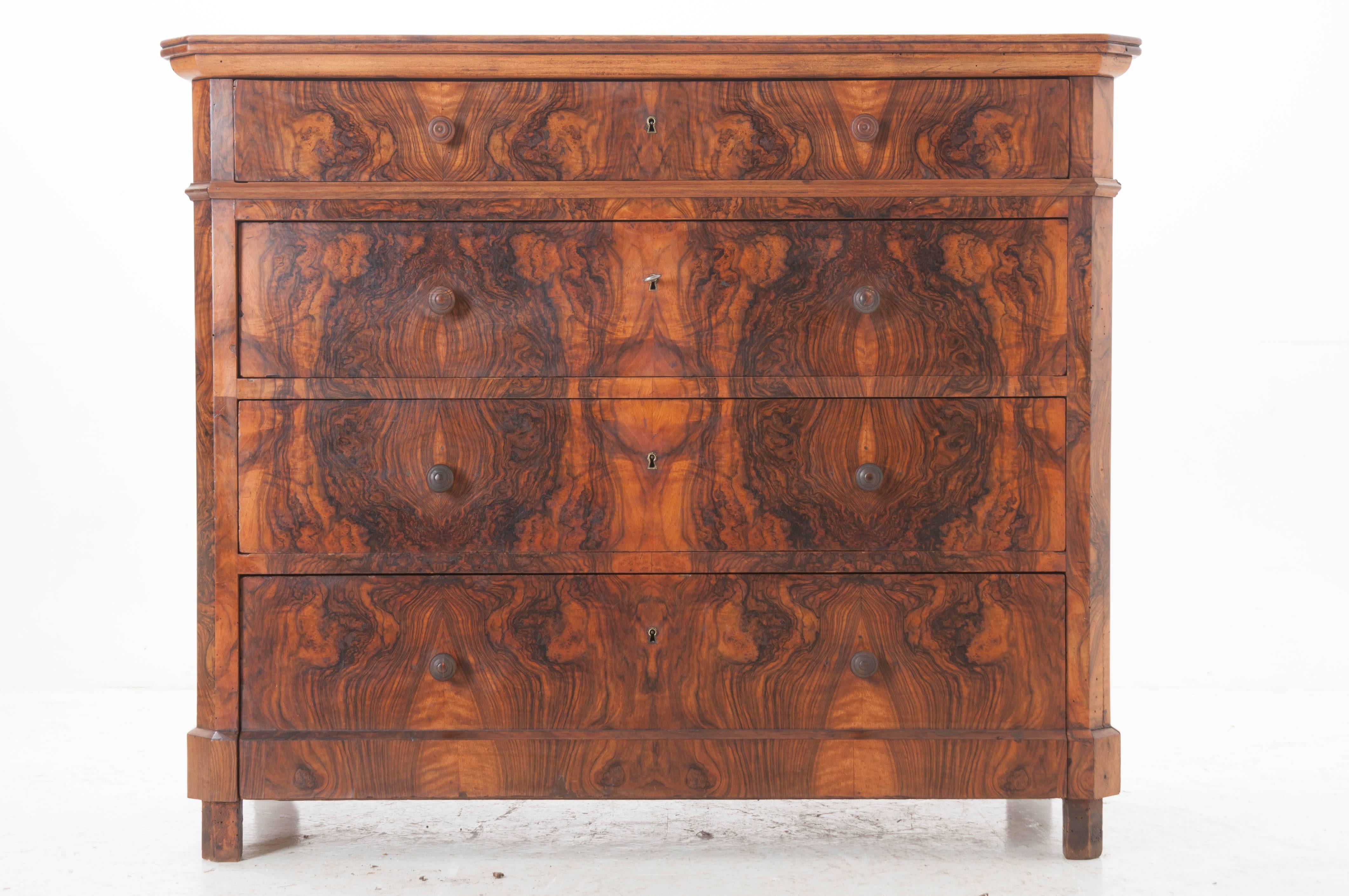 This four-drawer Louis Philippe commode features some of the most beautifully burl walnut that we have seen. Thoughtfully book matched; the furniture maker carefully selected each piece so the patterns in the burl align to give a mirrored effect.