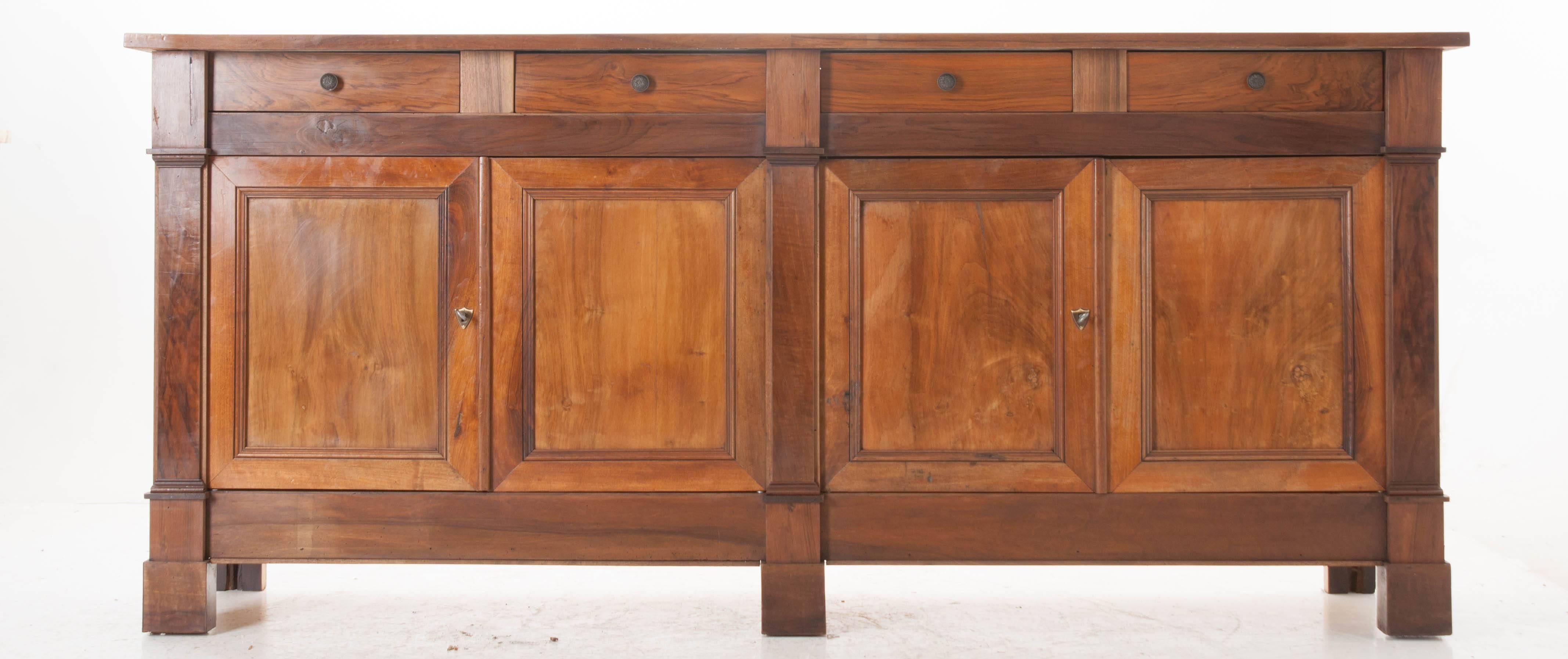 This Louis Philippe enfilade has been newly constructed, in France, using wood that dates back to the 19th century. New life has been breathed into the antique walnut, as it has been rejuvenated with a fresh coat of wax and careful polishing. Four
