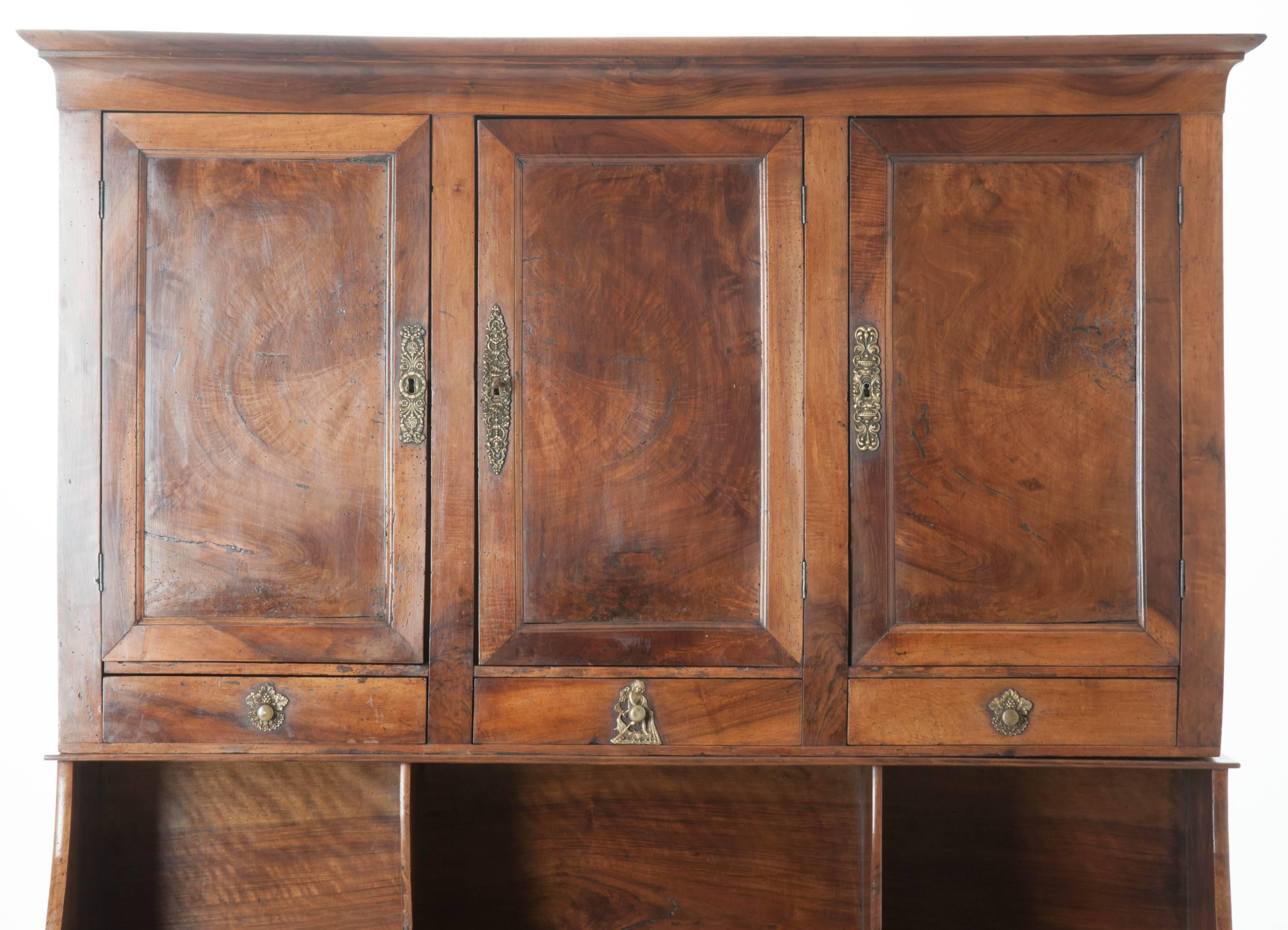 An extraordinarily handsome French Empire walnut secretary made in the middle of the 19th century in France. This exquisite piece boasts six drawers and five doors that provide ample storage for your writing essentials and other accessories. The