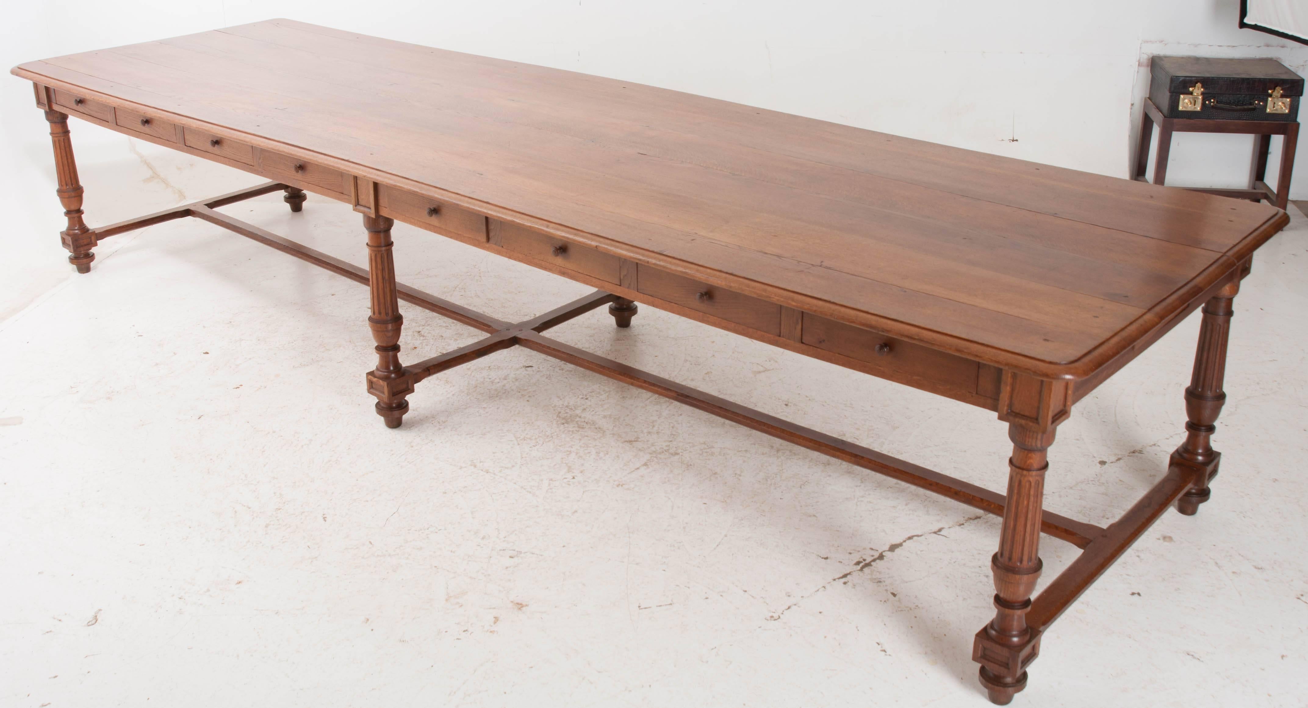 This absolutely stunning long table was originally used as a communal dining table at a nunnery in Rouen, France. This exceptional oak dining table has eighteen drawers found in the apron. With sharing and communal living being at the center of life