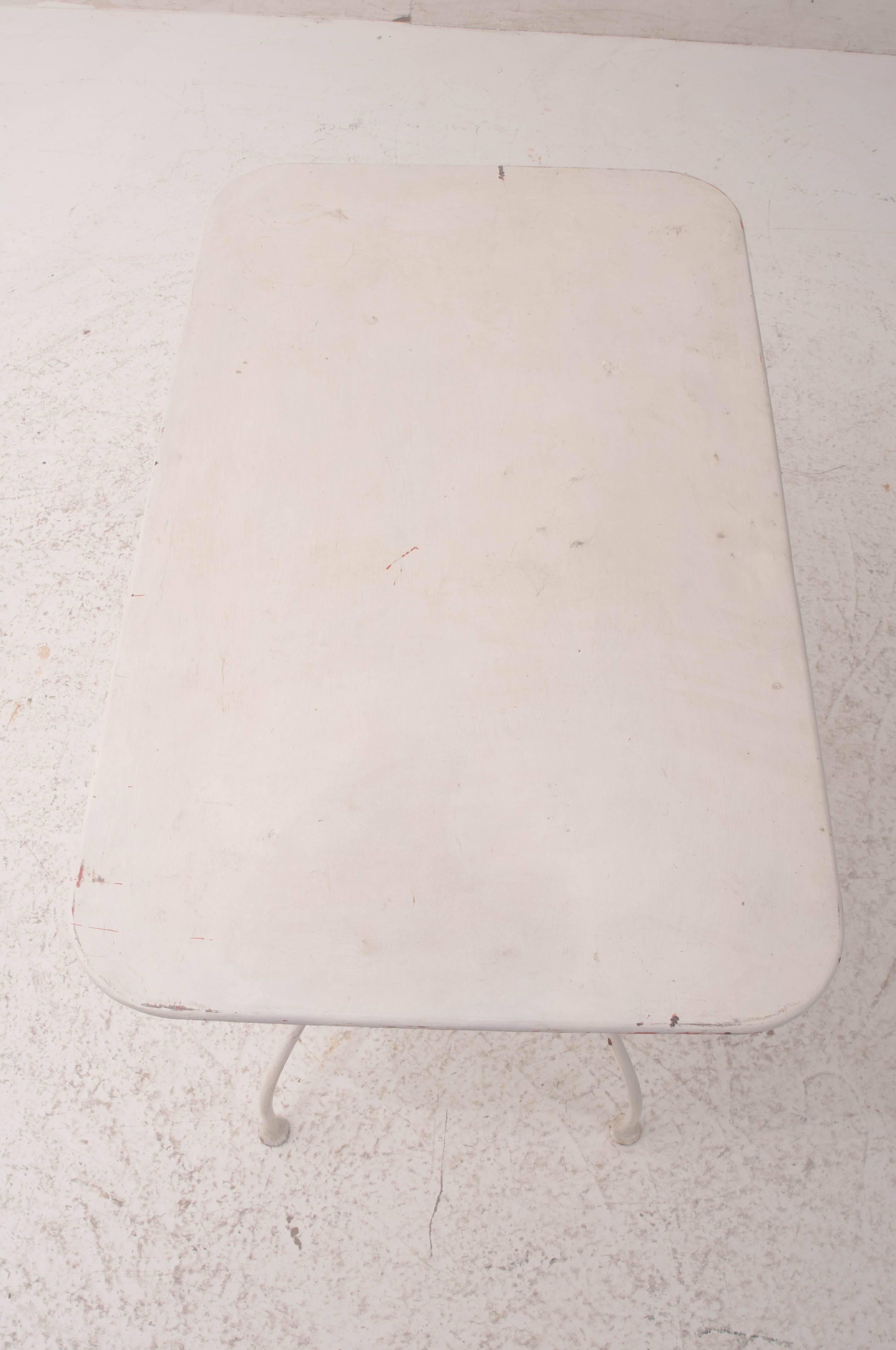 An adorable painted metal bistro table from 1930s, France. This piece would make a wonderful addition to your porch or patio. Its white paint has acquired a wonderful antique patina that is pleasing and versatile.