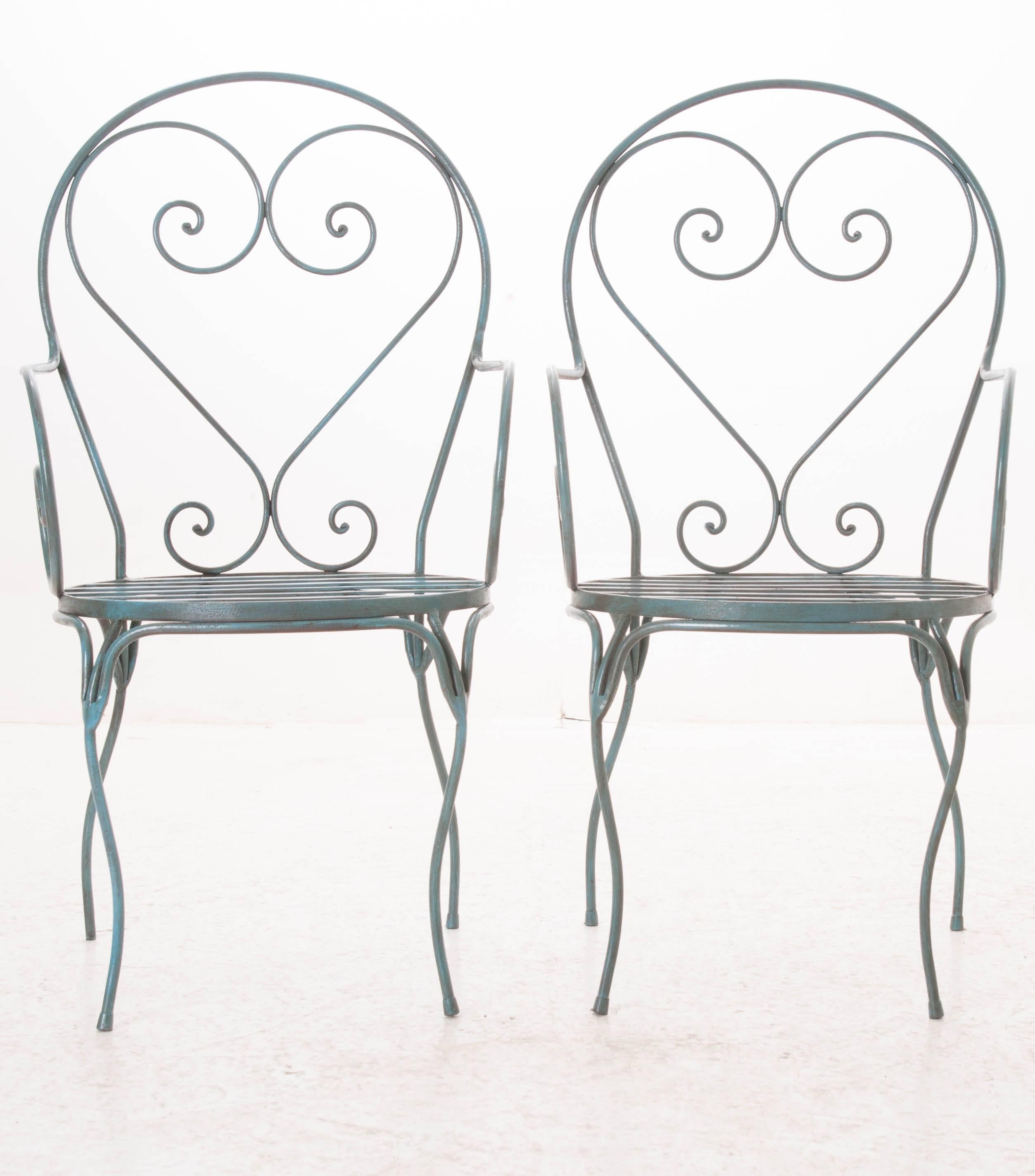 A sweet pair of vintage French metal chairs with a beautifully scrolled ironwork frame that has been painted an extraordinary shade of blue. These metal chairs could be used both indoors and out, providing a pop of color wherever they go!
 