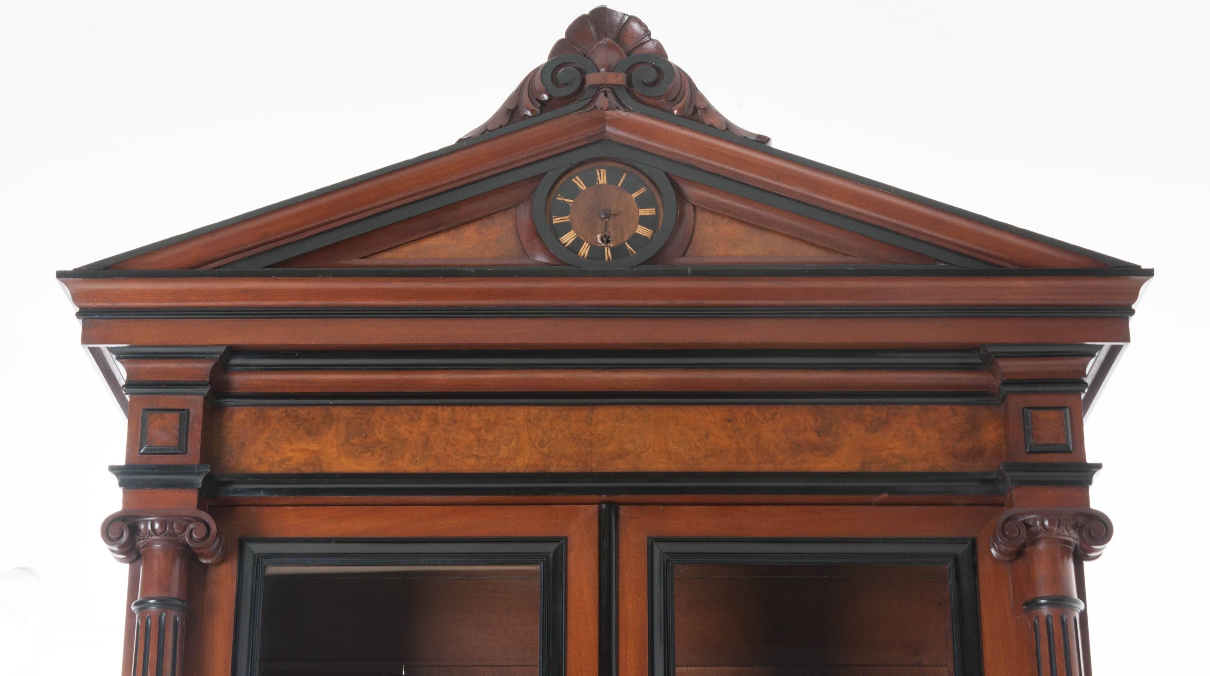 An outstanding French Napoleon III mahogany buffet à deux corps featuring wonderfully detailed carvings from the mid-late 19th century. Exceptional ebony trim and details complement the burl mahogany and give straight lines to this otherwise figured