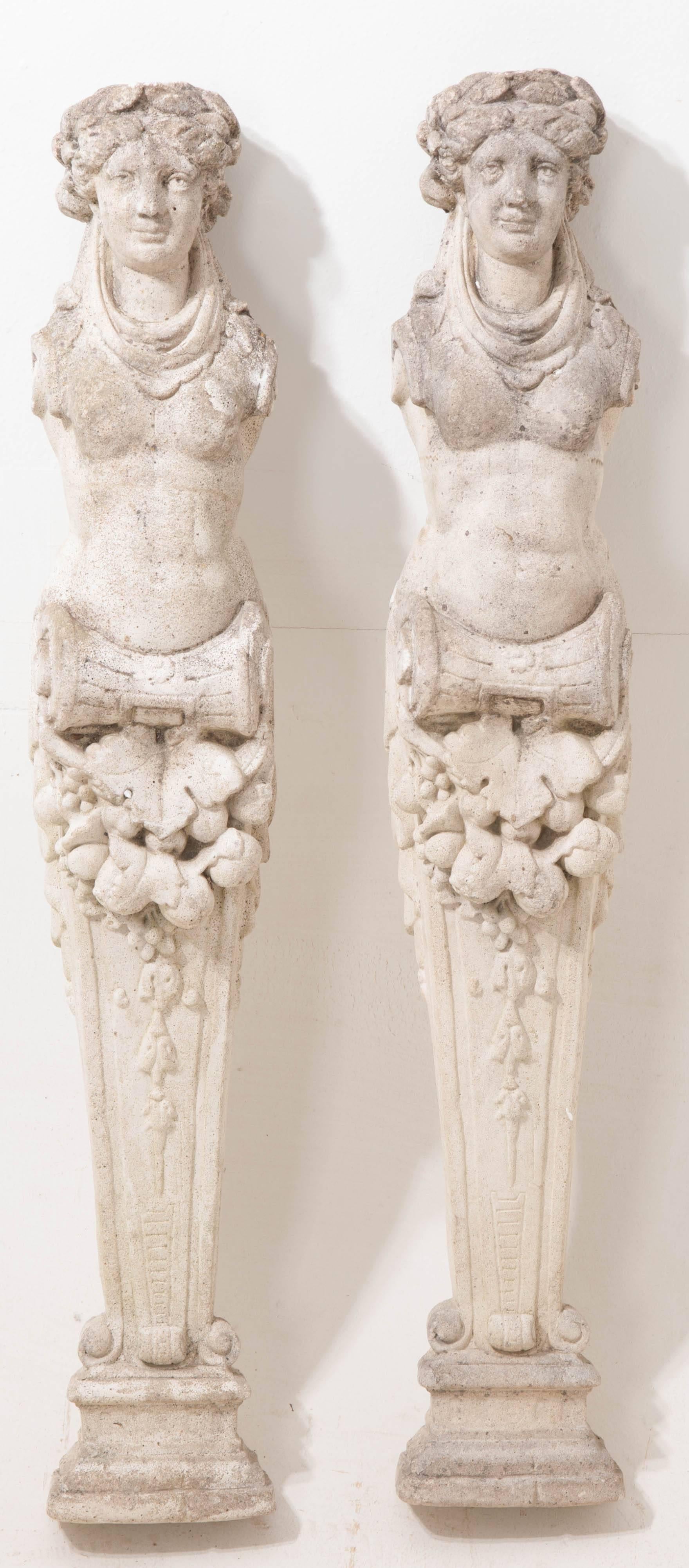 A fabulous feminine pair of reconstituted stone decorative mantel legs from 19th century, France. These ladies were originally the decorative legs, or pillars, of a complete stone fireplace mantel. Today, they make wonderful decorative objects that