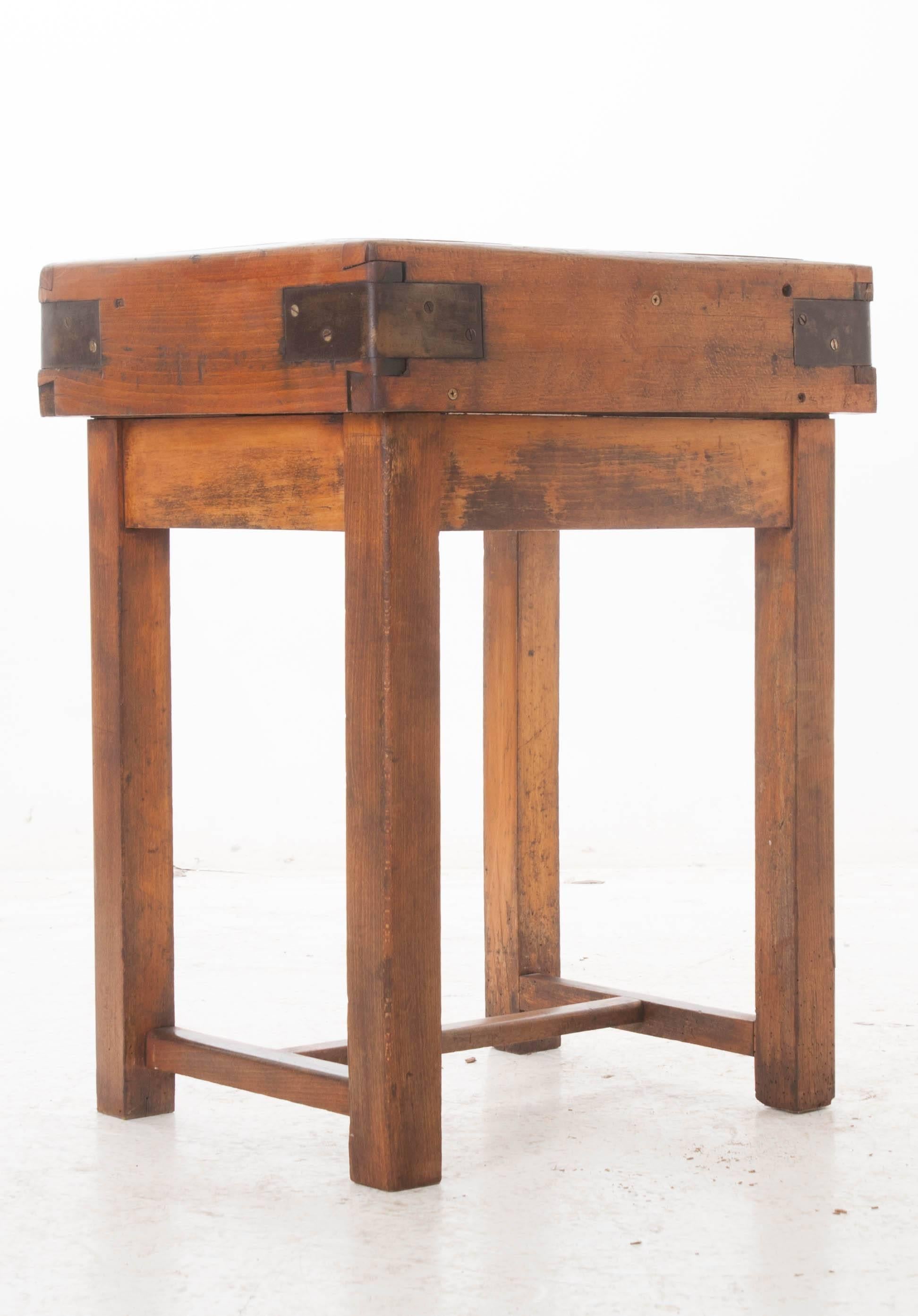 A wonderful pine table with bound butcher block top from 19th century, France. This functional antique teems with character and has acquired a phenomenal patina over its lifetime. Knife marks left from butchers and cooks long ago can still be seen