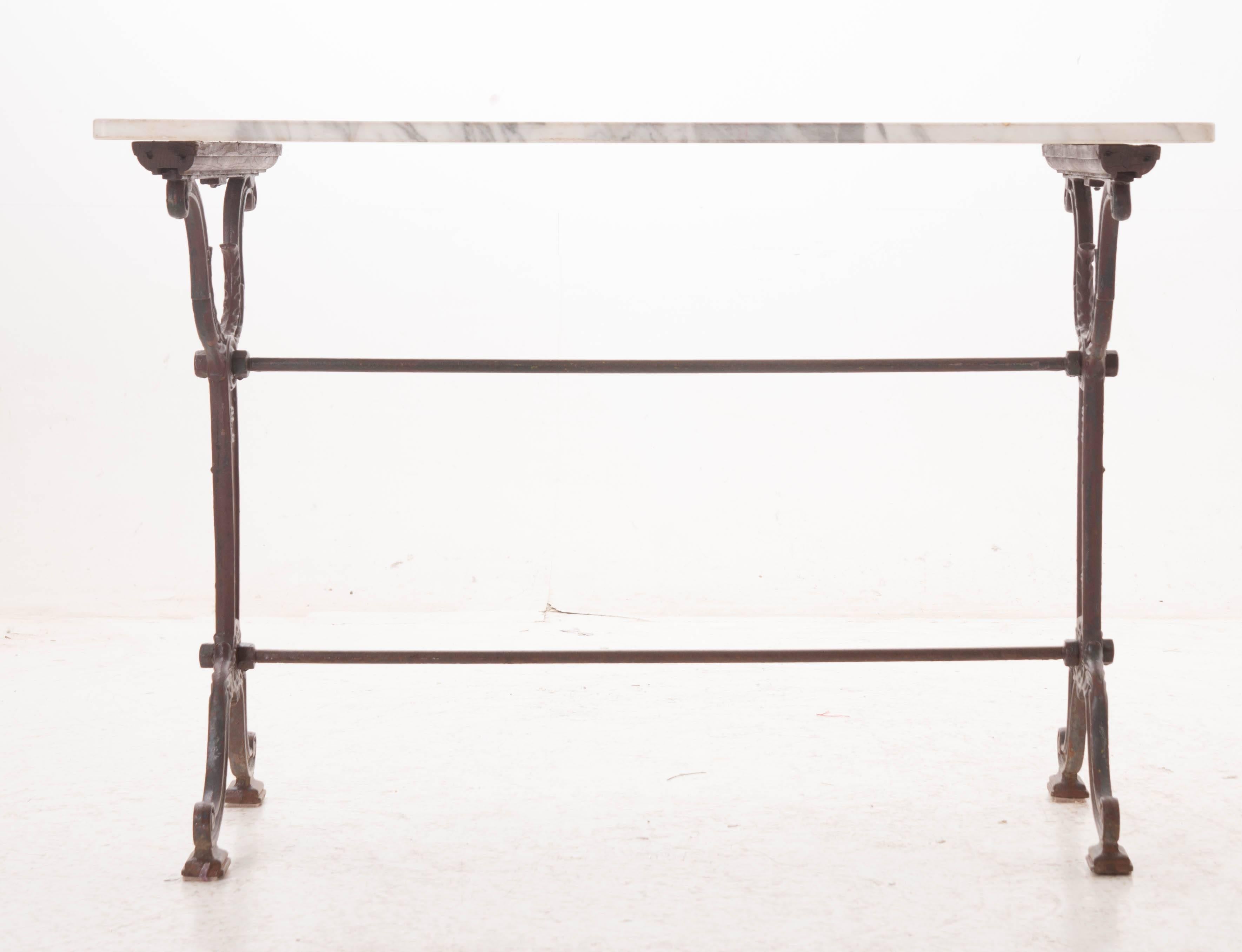 A fabulous cast iron bistro table from early 20th century, France. A great size for serving, this marble top table would make a spectacular addition to your patio or outdoor space.