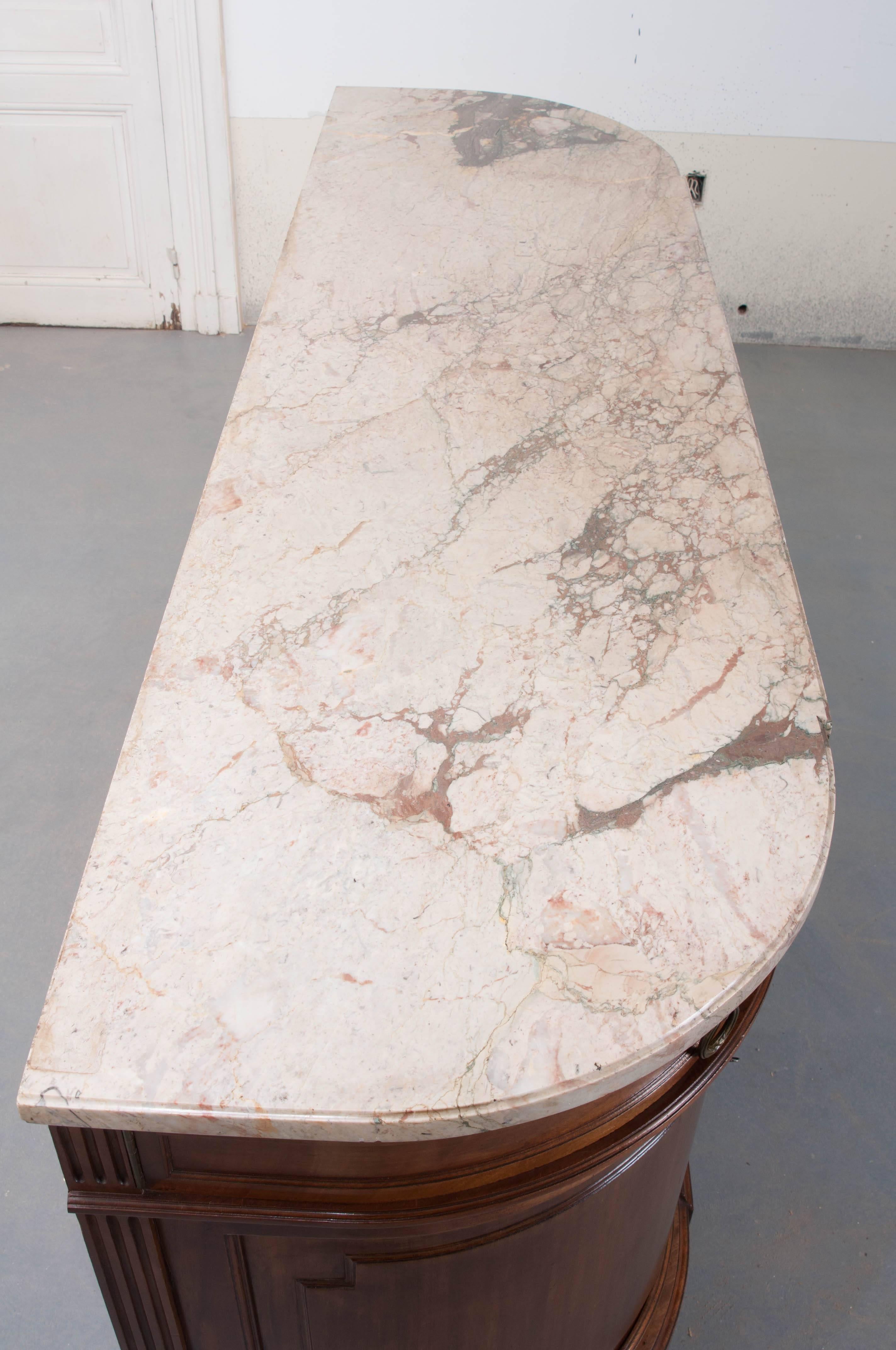 A fantastic four door marble-top mahogany enfilade from 19th century France. This half-moon (Demilune) shaped enfilade has an extraordinary shaped marble top with a slight breakfront, that matches the piece perfectly. The marble is in excellent