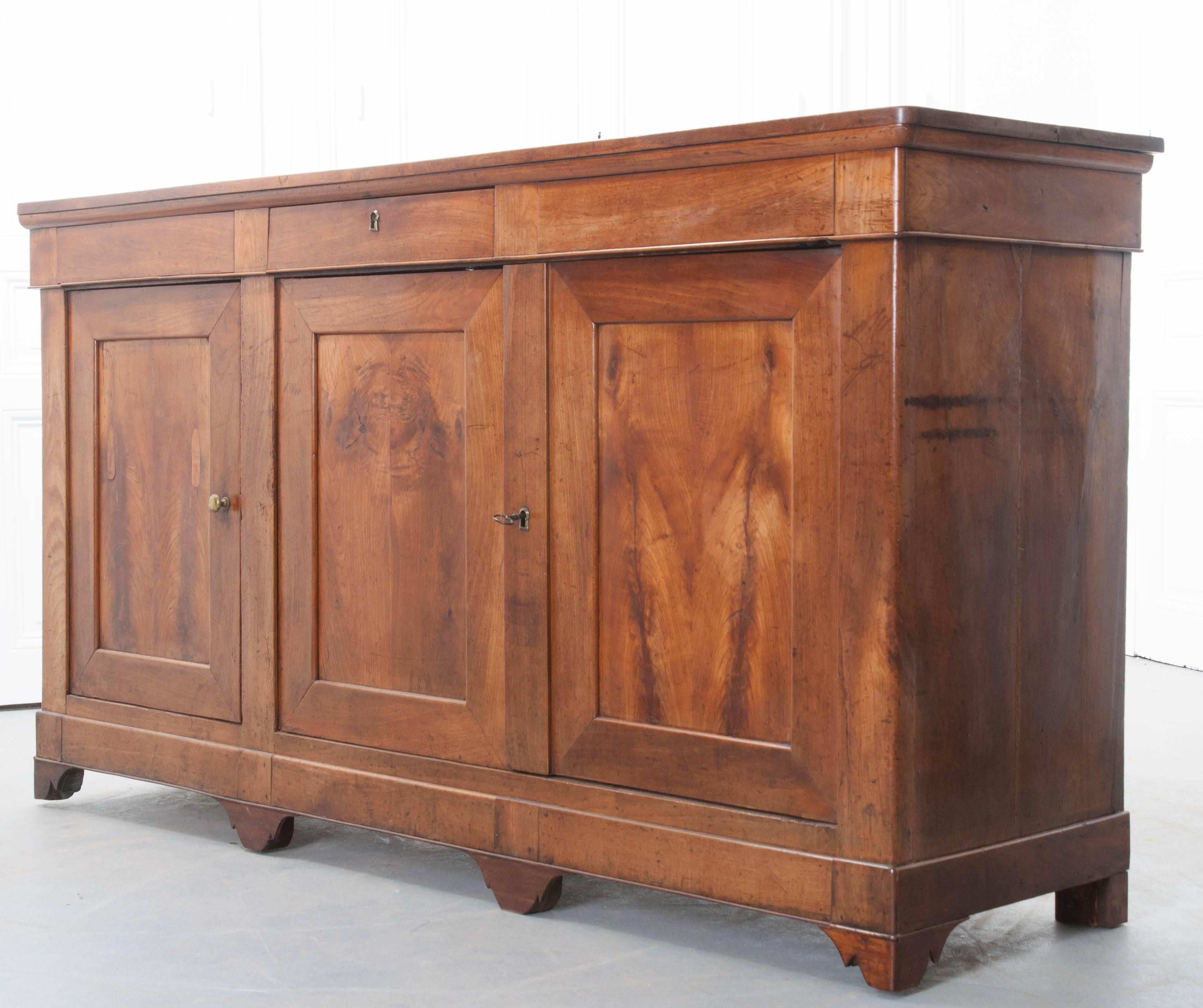 A beautiful solid walnut French Louis Philippe enfilade from the end of the 19th century. The wonderfully toned walnut is warm with a rich and lustrous quality. The apron houses a single drawer with a working lock. The piece has two interior storage