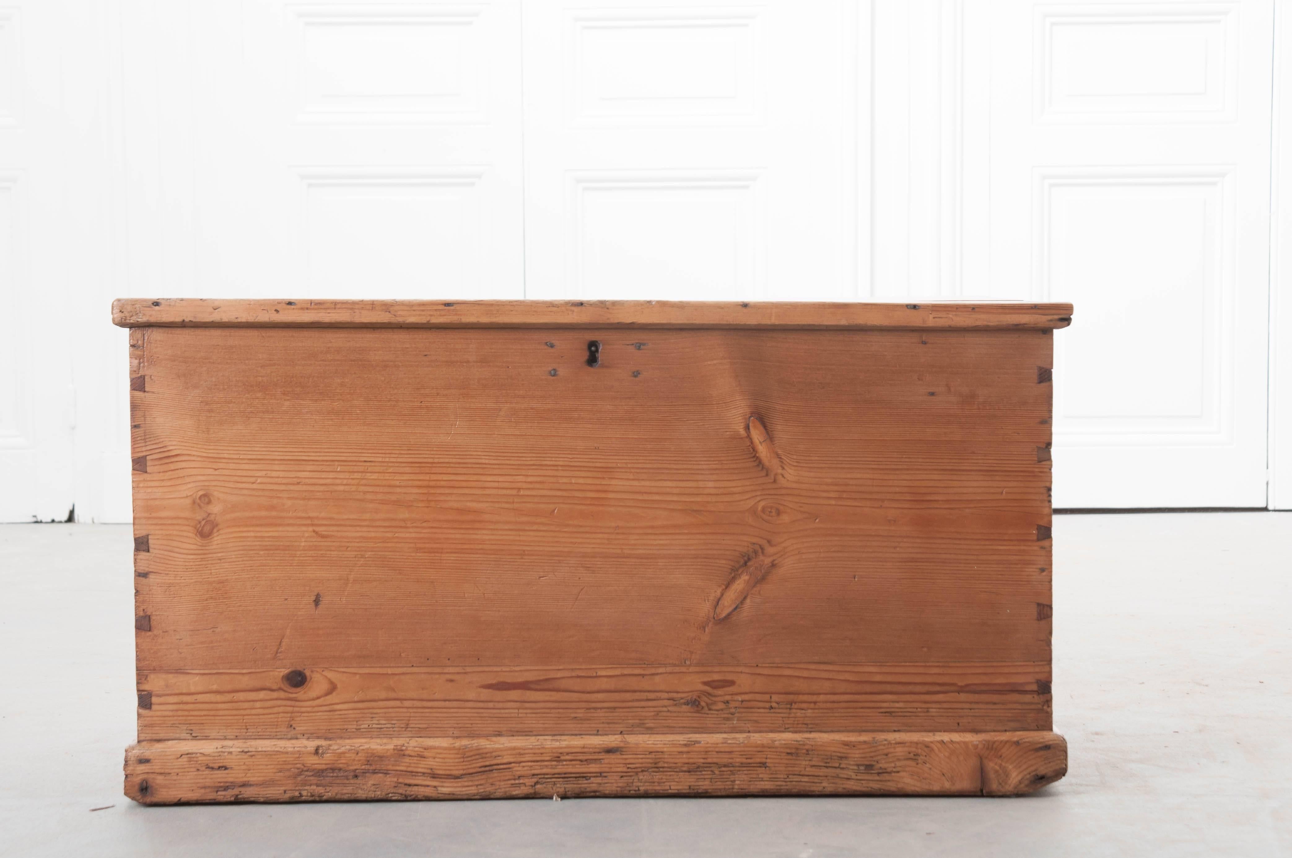 A wonderful pine trunk from the English countryside. Made at the end of the 19th century, this trunk carries with it a patina that is full of warmth and character. The trunk has its original steel bail handles and the corner joinery is particularly