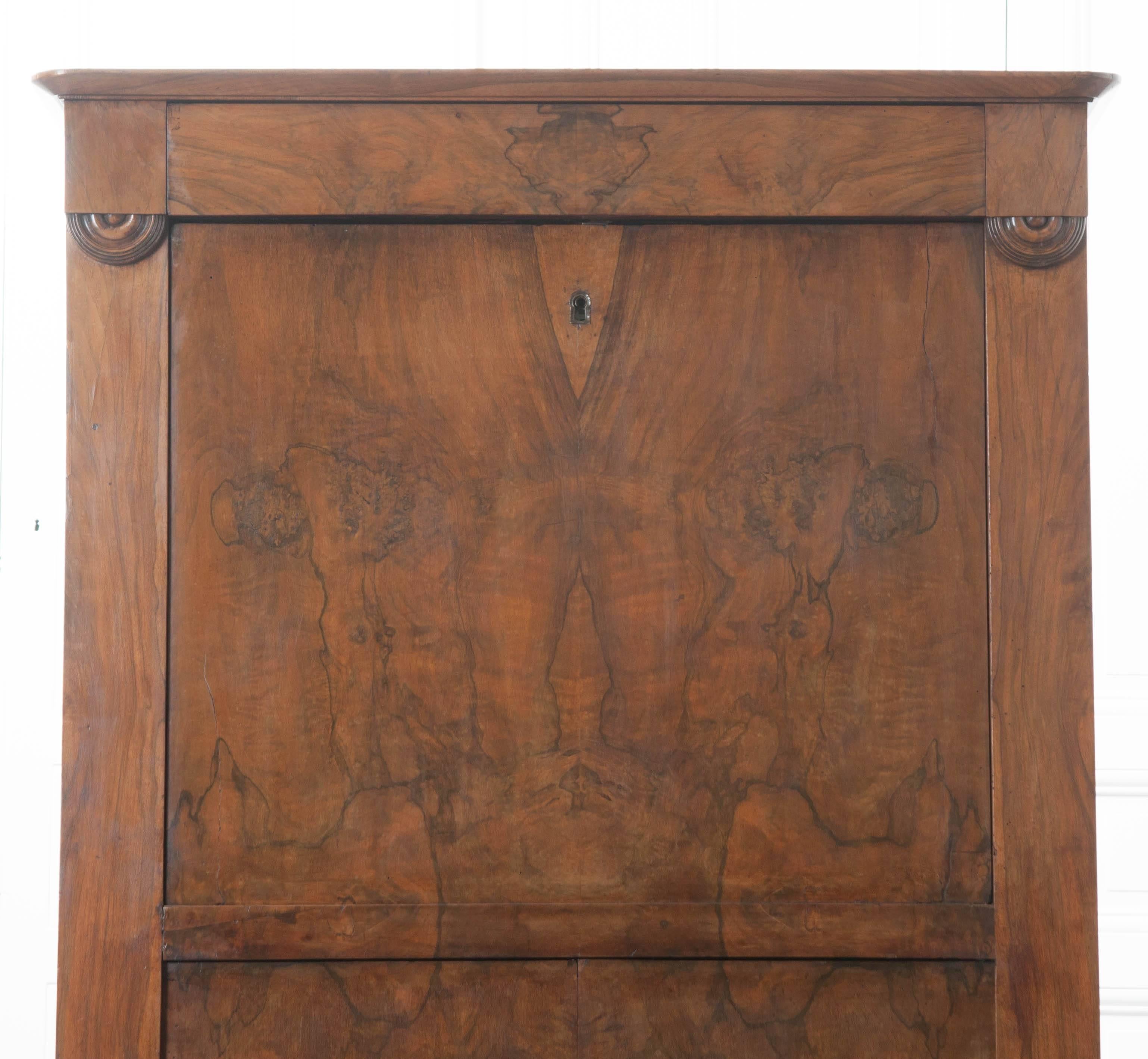 A spectacular burl walnut desk from 19th century, France. A drawer can be found at the top of the desk with no hardware. The front of the desk folds down, revealing a leather topped work surface, storage and five drawers that will aid in keeping