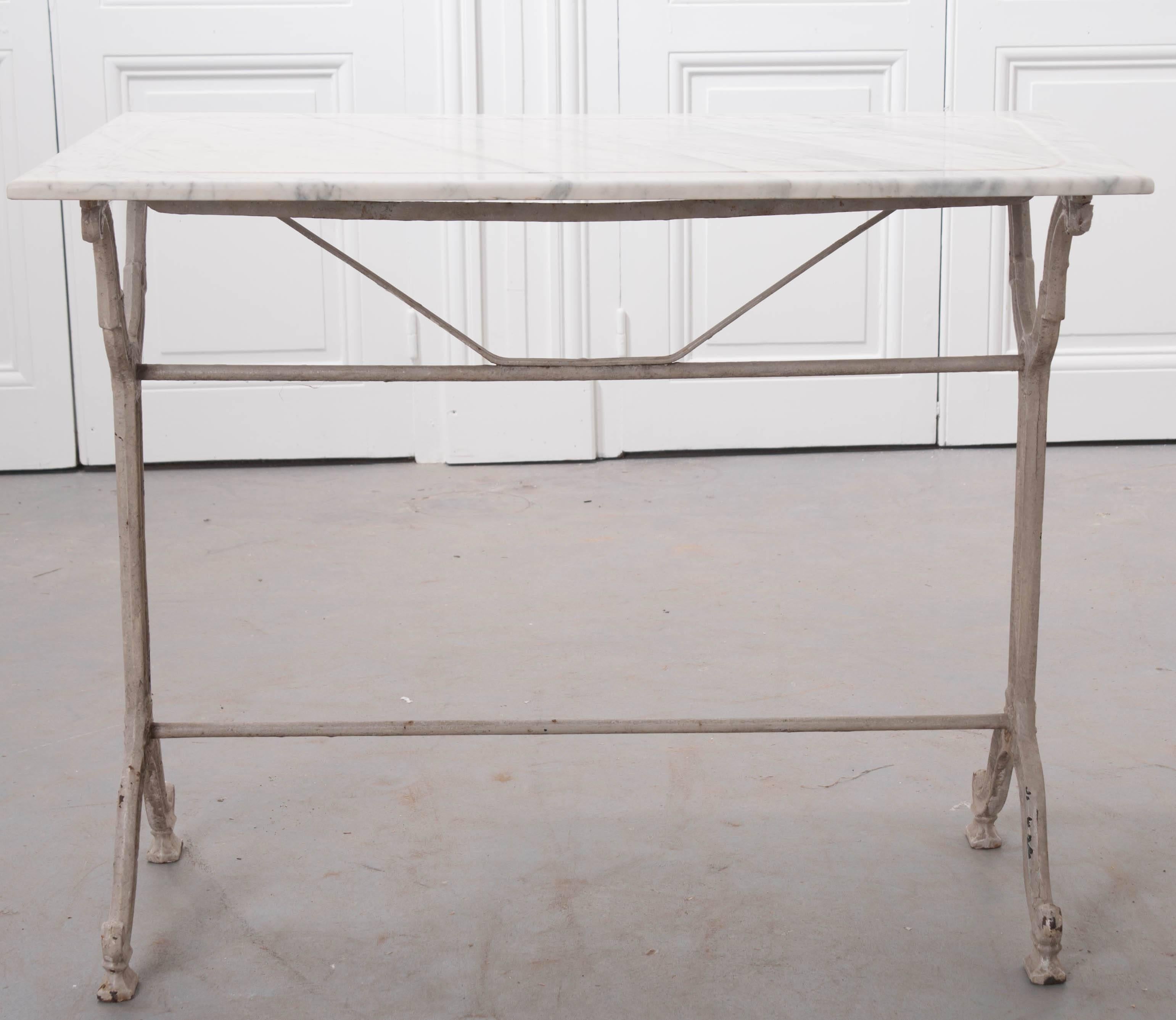 This marvellous marble top bistro or garden table was made in France towards the end of the 19th century. The white marble top is antique and in excellent condition with no blemishes and soft grey veins throughout. The top also features a perimeter