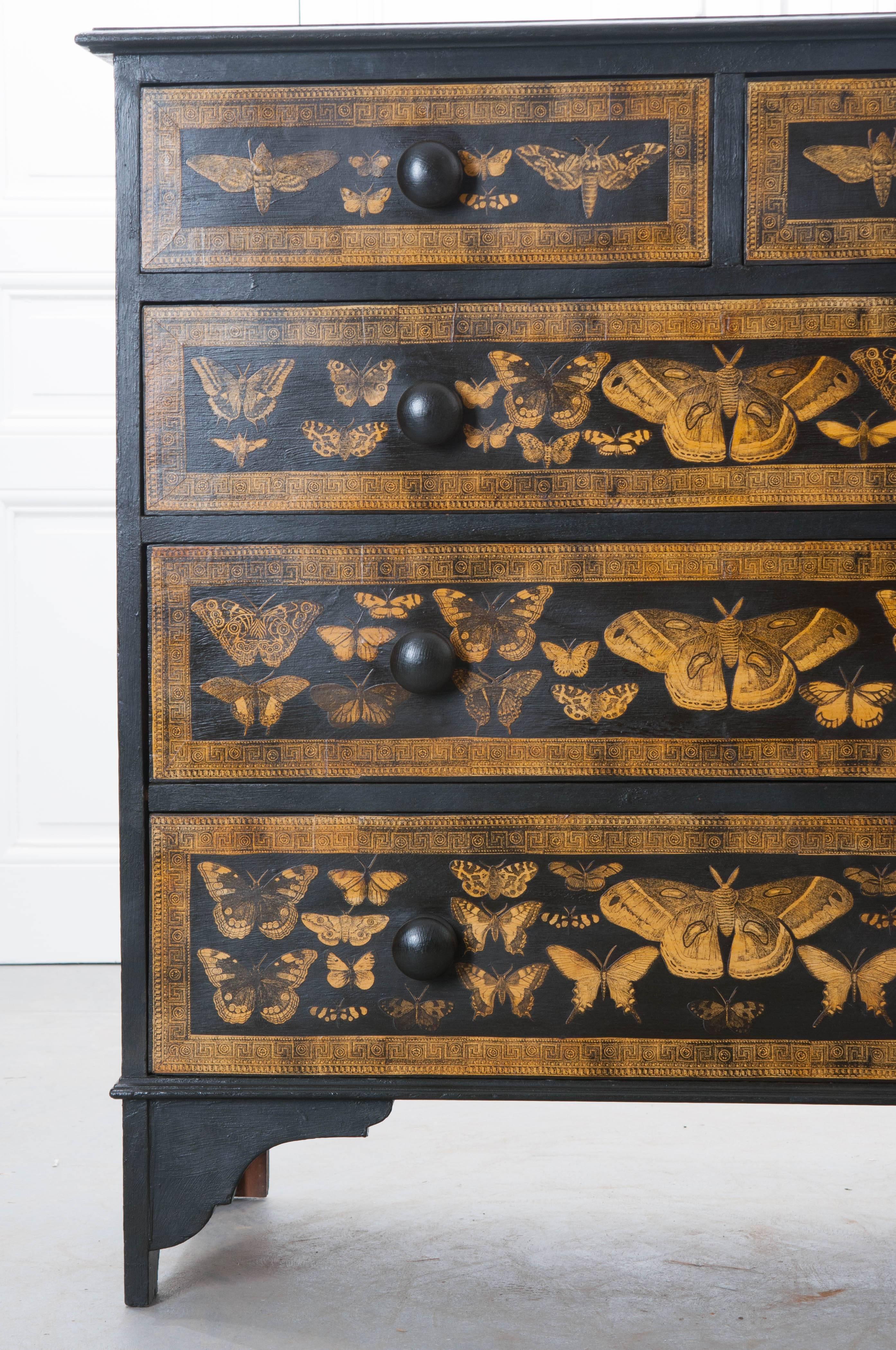 An incredible five drawer Victorian painted chest of drawers from 19th century, England, that has more recently had beautiful gold moths decoupaged onto the piece. The chest has two smaller top drawers with three larger drawers beneath that are