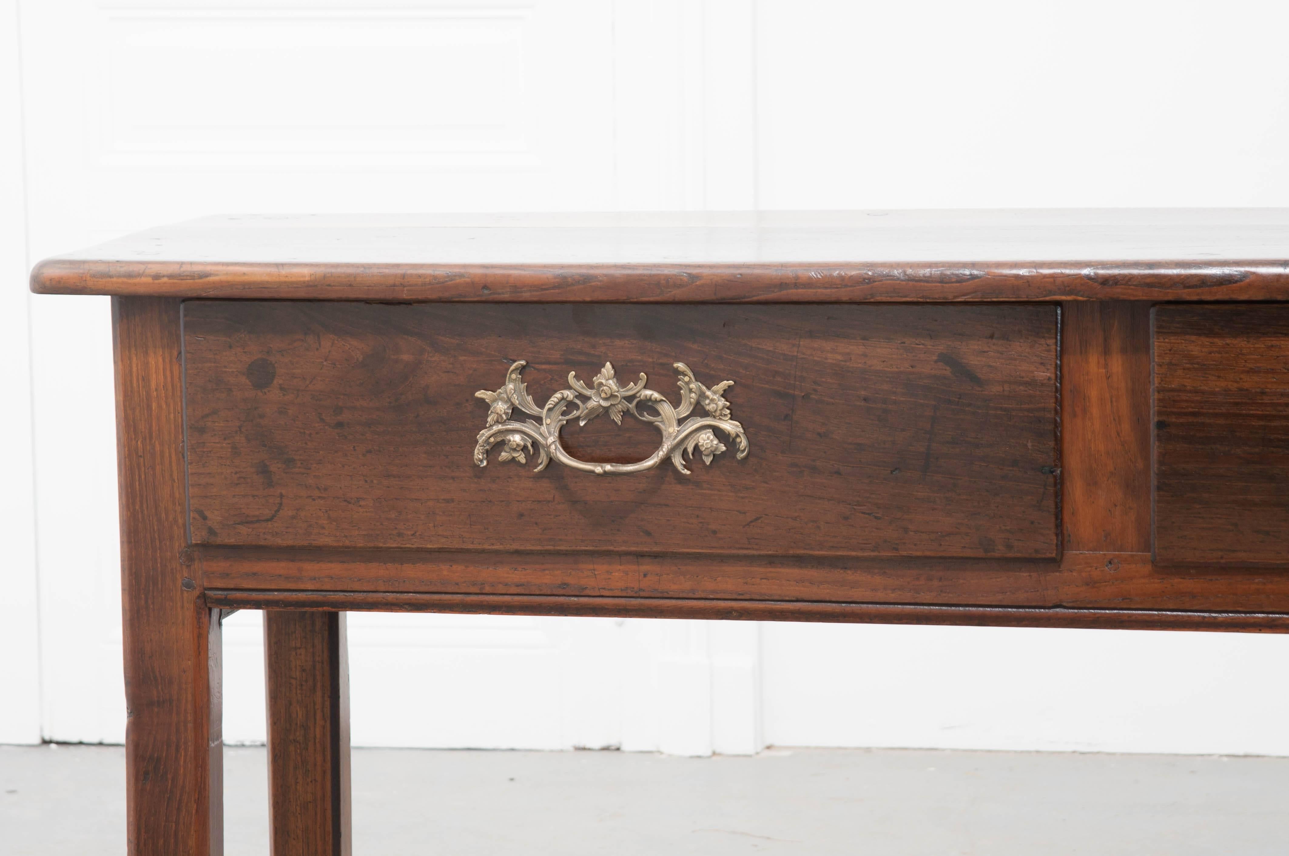 19th century English oak sideboard with three large drawers and exceptional French brass drawer pulls. This handsome, solid oak, antique English piece has rich, deep color with exceptional patina. The three drawers provide heaps of storage and are