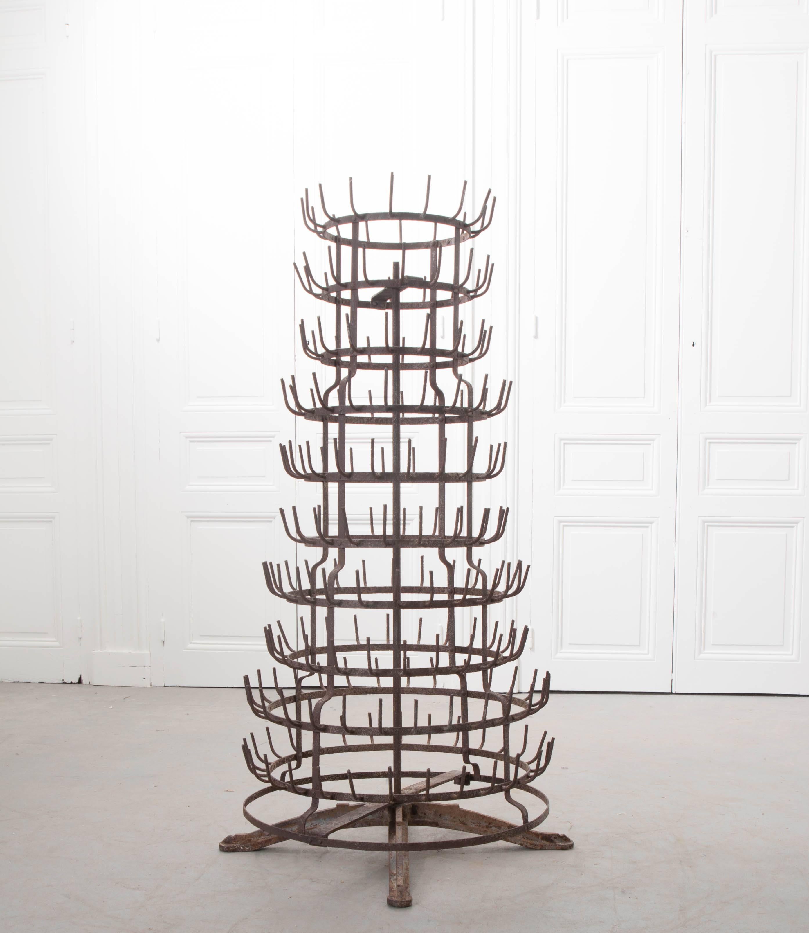 This interesting antique is used to dry glass bottles, usually wine, and almost always in France! This particular drying rack features a circular design that is affixed to a base, allowing the rack to be spun around for easier loading and unloading.