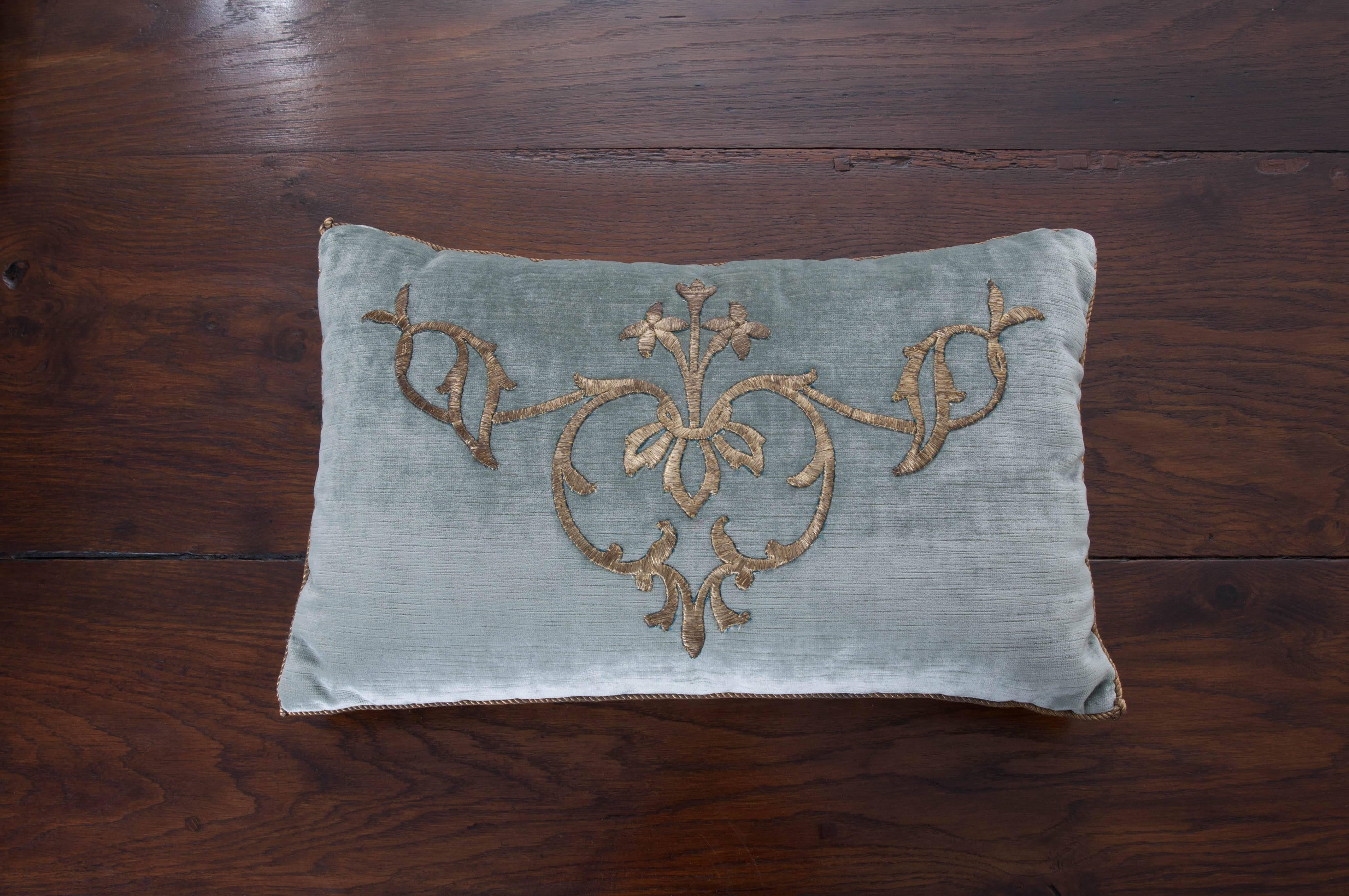 Antique Ottoman Empire raised gold metallic embroidery on pale French blue velvet. Hand trimmed with vintage gold metallic cording knotted in the corners.

