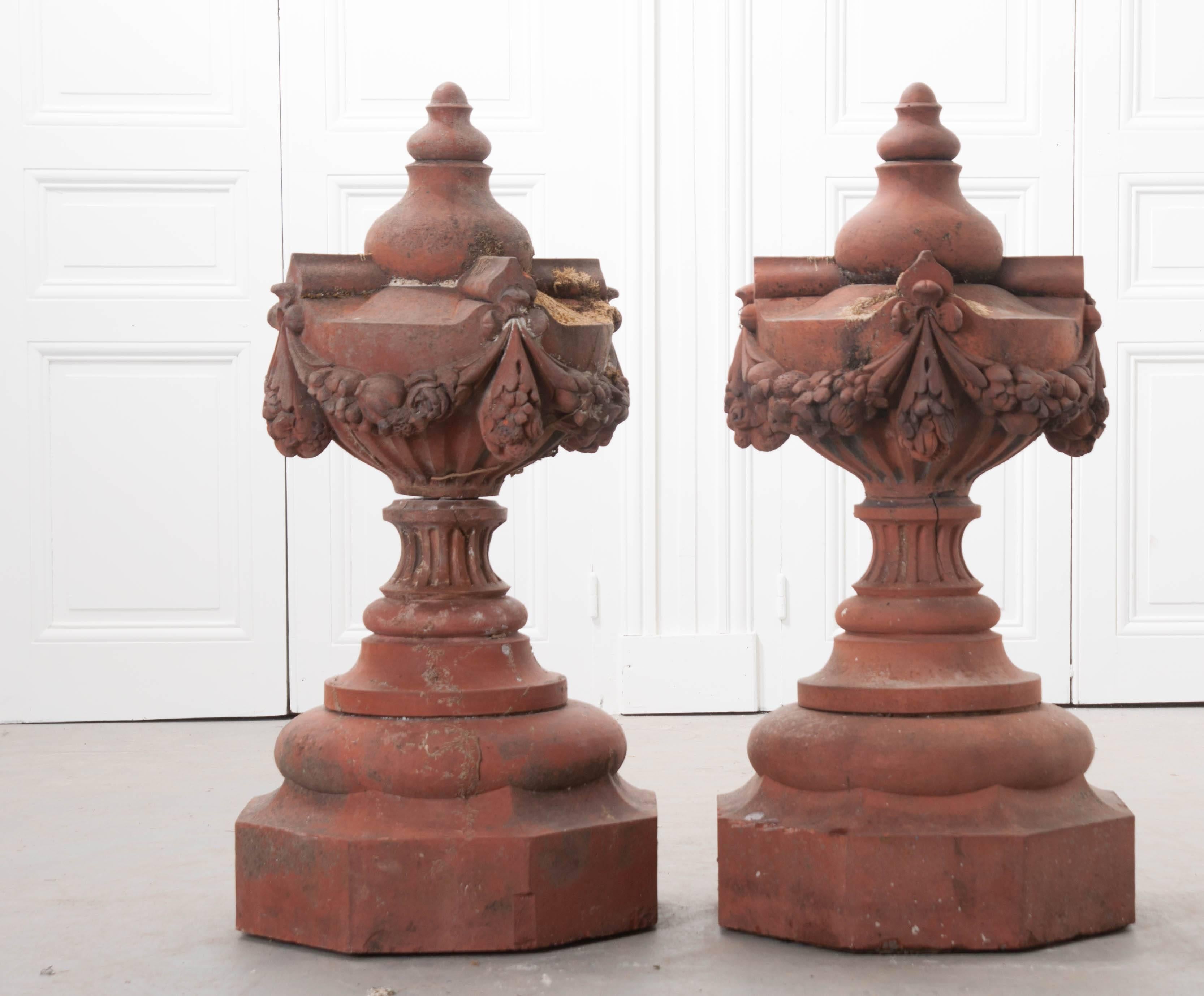 A stunning pair of antique terra cotta finials from 19th century, France. These beautiful fixtures have a superb brick color that has been aged from decades of exposure to the elements. This exposure has resulted in a fabulous patina that is second