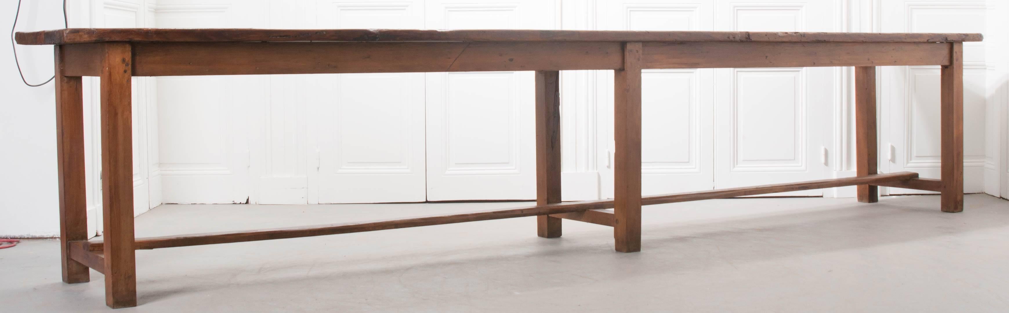 A terrific long, narrow pine work table from 19th century, France. Exceptional patina envelopes the aged pine, created from decades of use. The table is made of solid pine and fashioned together using peg and hole joinery. The table's length