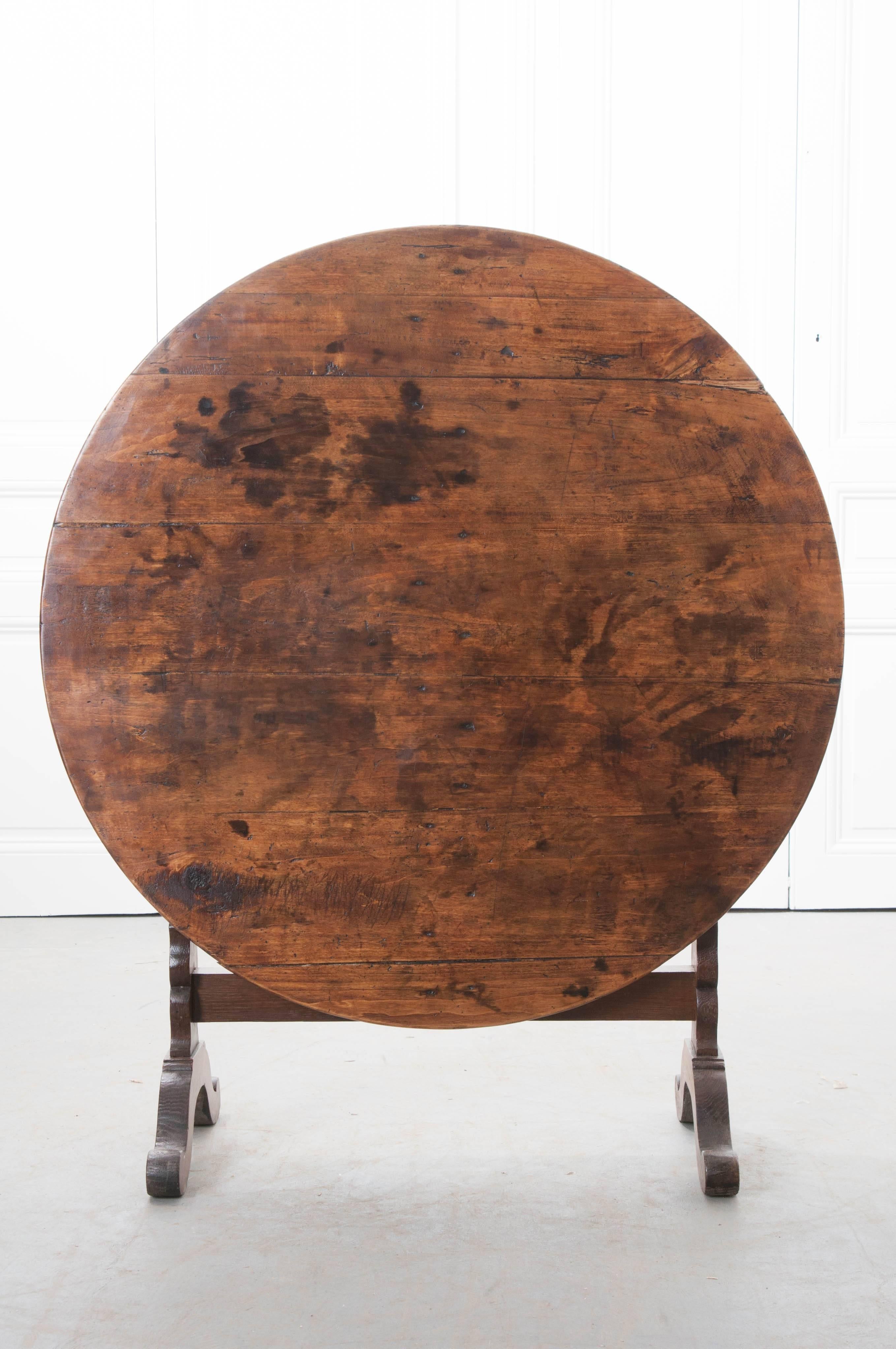 A very special oak and walnut vendange table, also known as a wine taster's table, made in France, circa 1860. The table has a round top, made of walnut, while the styled base is made of oak. This table would have been brought out for tasting wine