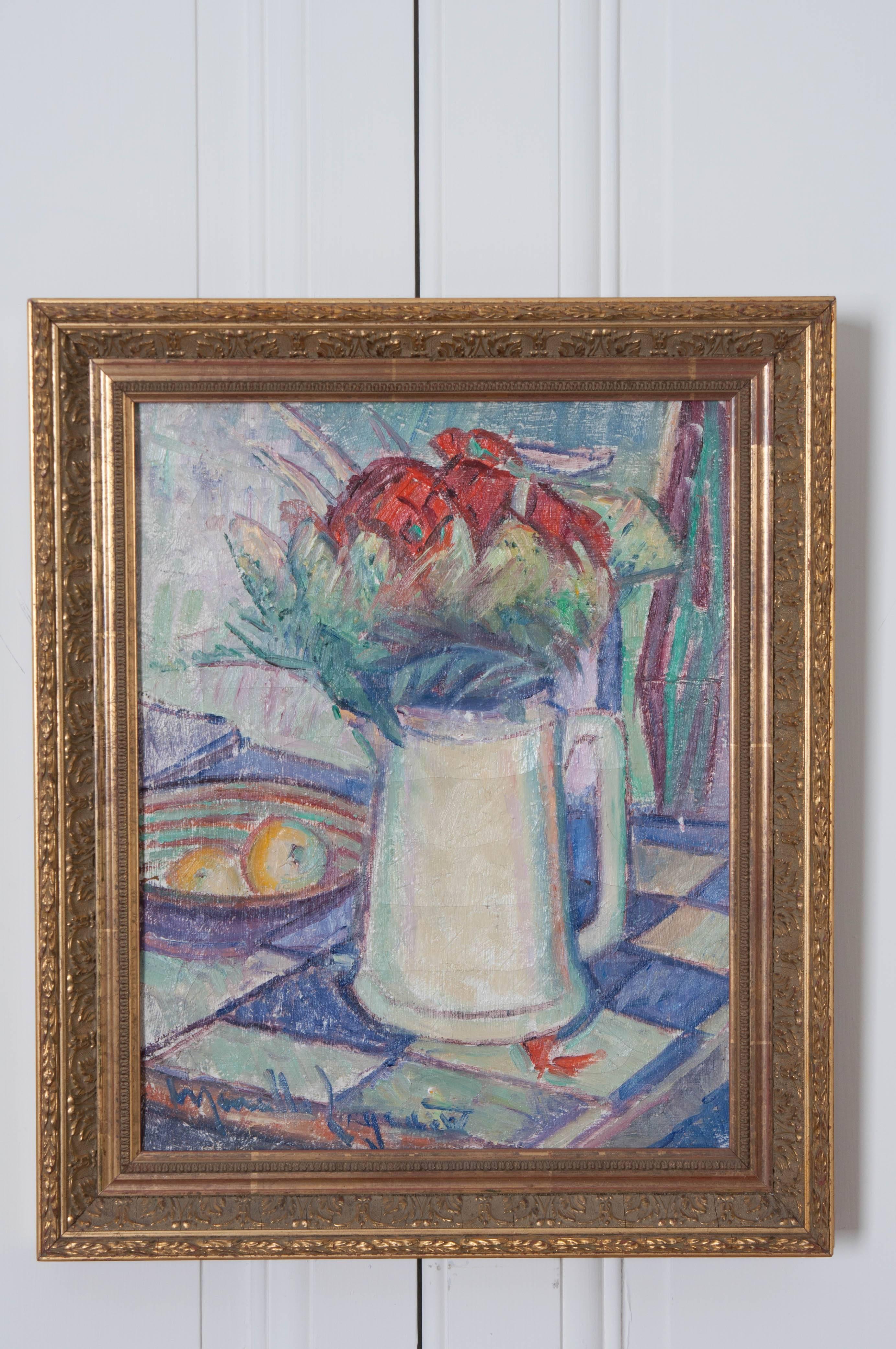 A colorful antique oil painting from the end of the 19th century, France. The work exhibits a pitcher on a checkered counter or tabletop, full of flowers. A bowl containing fruit is at its side. The piece is set in a remarkable gold gilt frame that