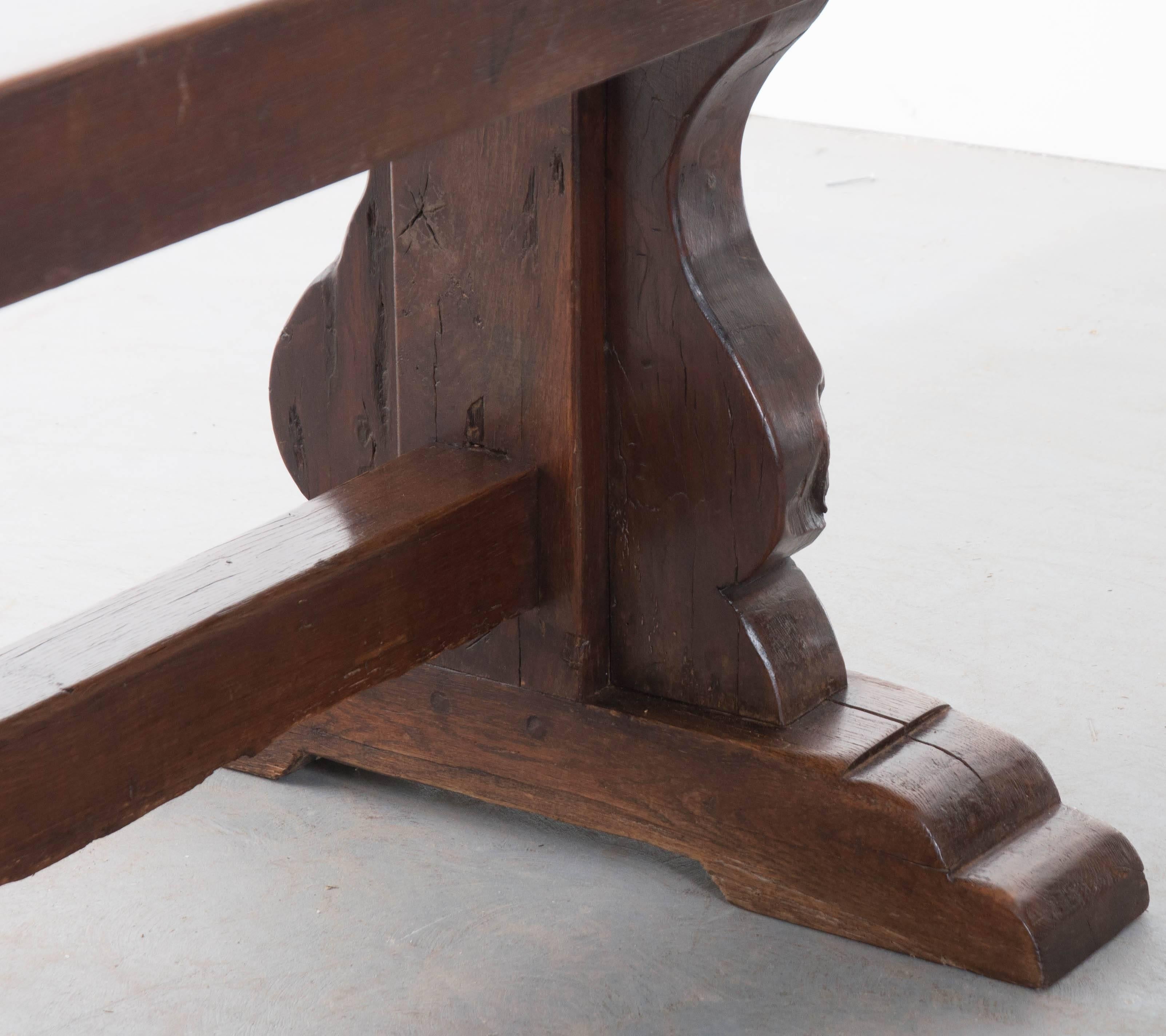 Thick slabs of solid oak were employed to create this stunning French oak trestle table from the early part of the 19th century. The Primitive oak has achieved a remarkable patina over the course of its lifetime, having entertained many guests in