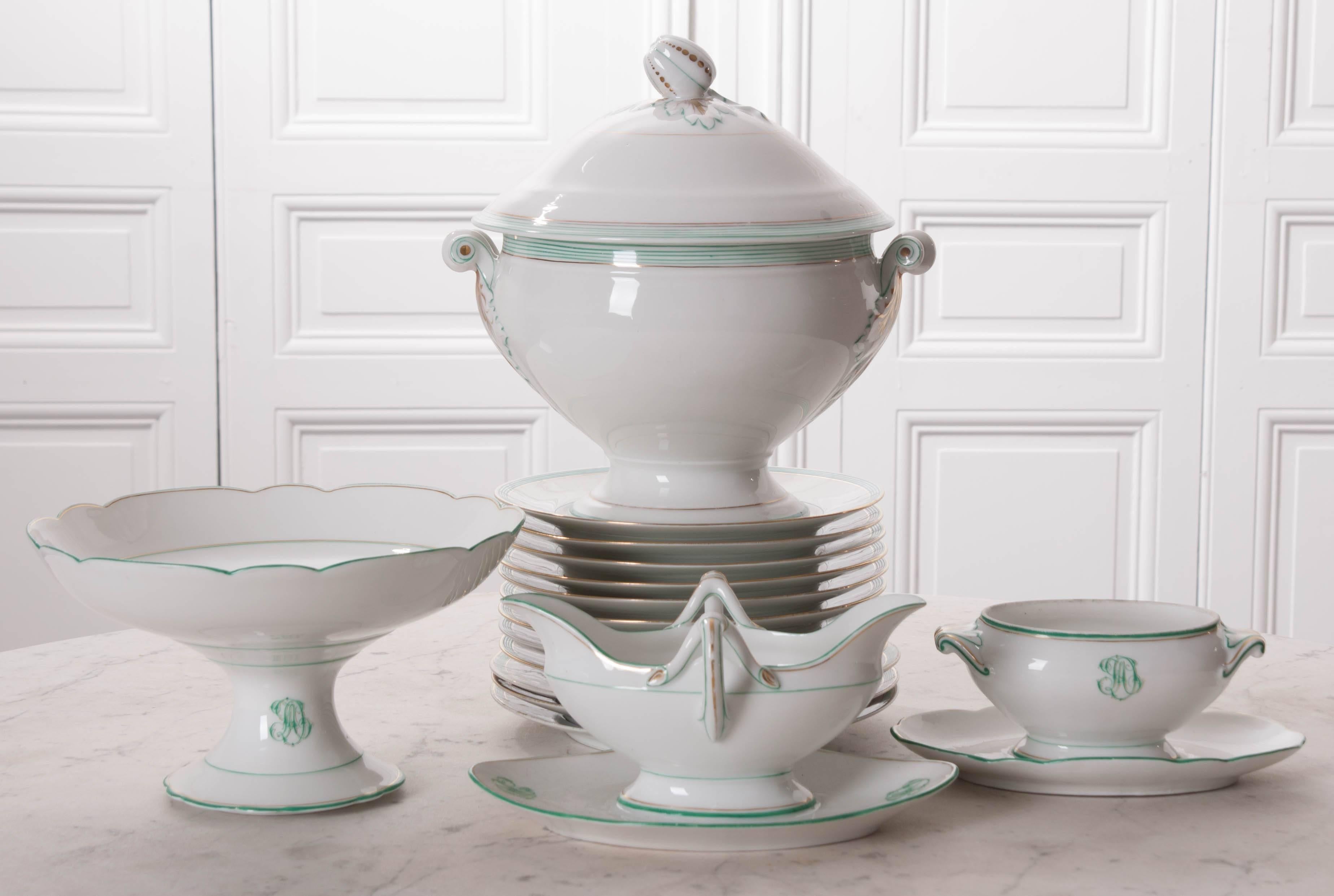 A beautiful set of old Pairs porcelain dinner pieces from mid-19th century France. The service pieces are monogrammed and trimmed in a lovely blue-green and gold. The soup tureen has styled handles with foliate details and a lid with a pumpkin