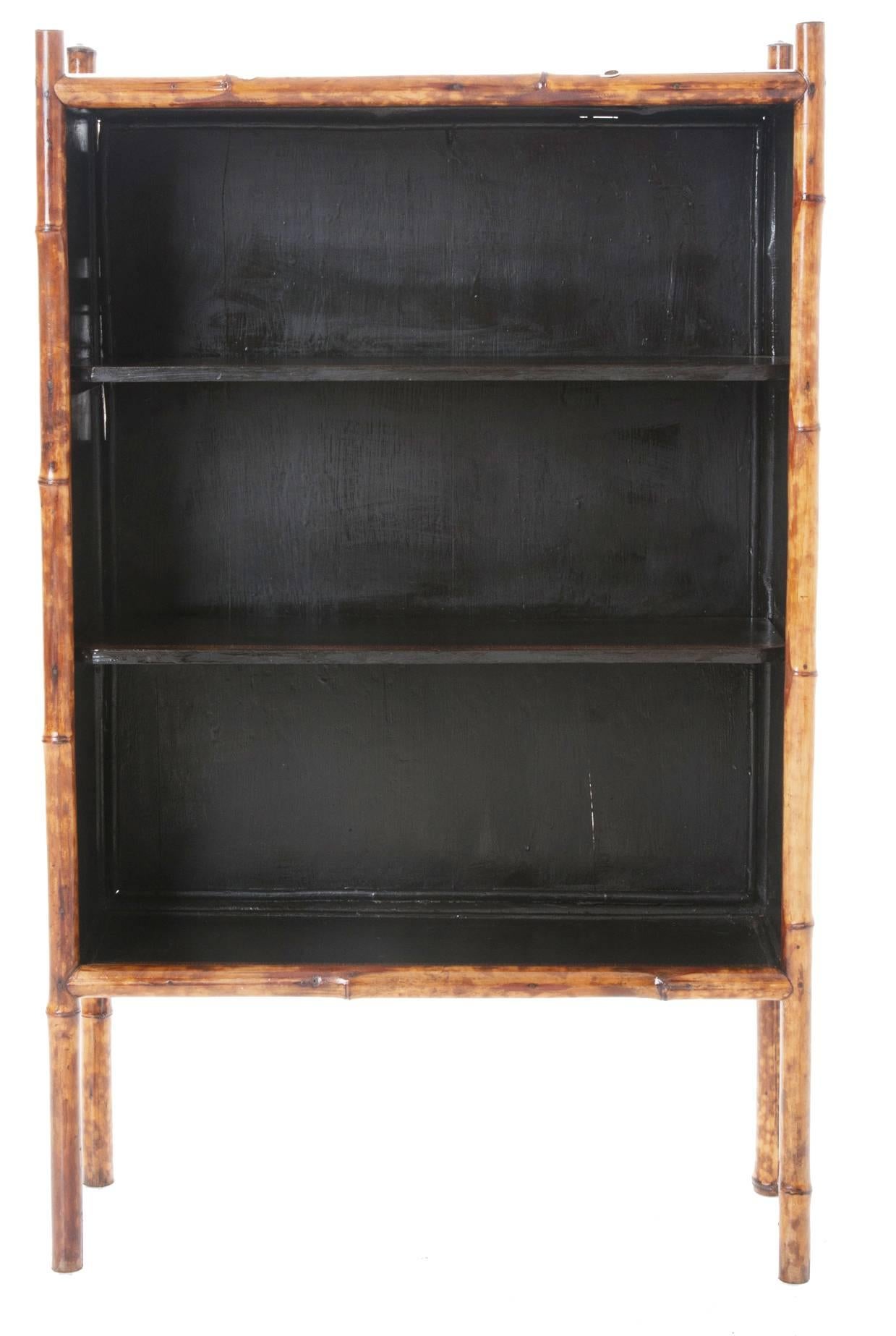 English 1890s bamboo bookshelf is sturdy and re-finished with black paint overlaid with decoupage of fish and an interesting boarder.
 