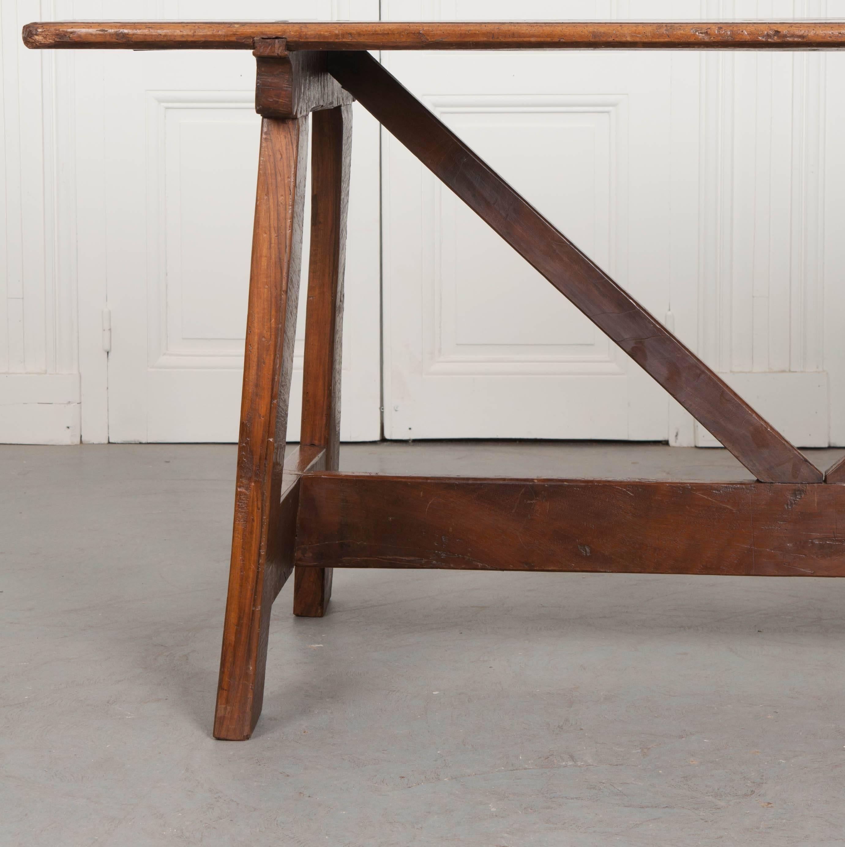 A remarkable 19th century farmhouse table, made of walnut, from Portugal. The table is made of hand-carved walnut, that is stunningly beautiful, with some edges that have been selectively left rough. These give the table an even more Provincial