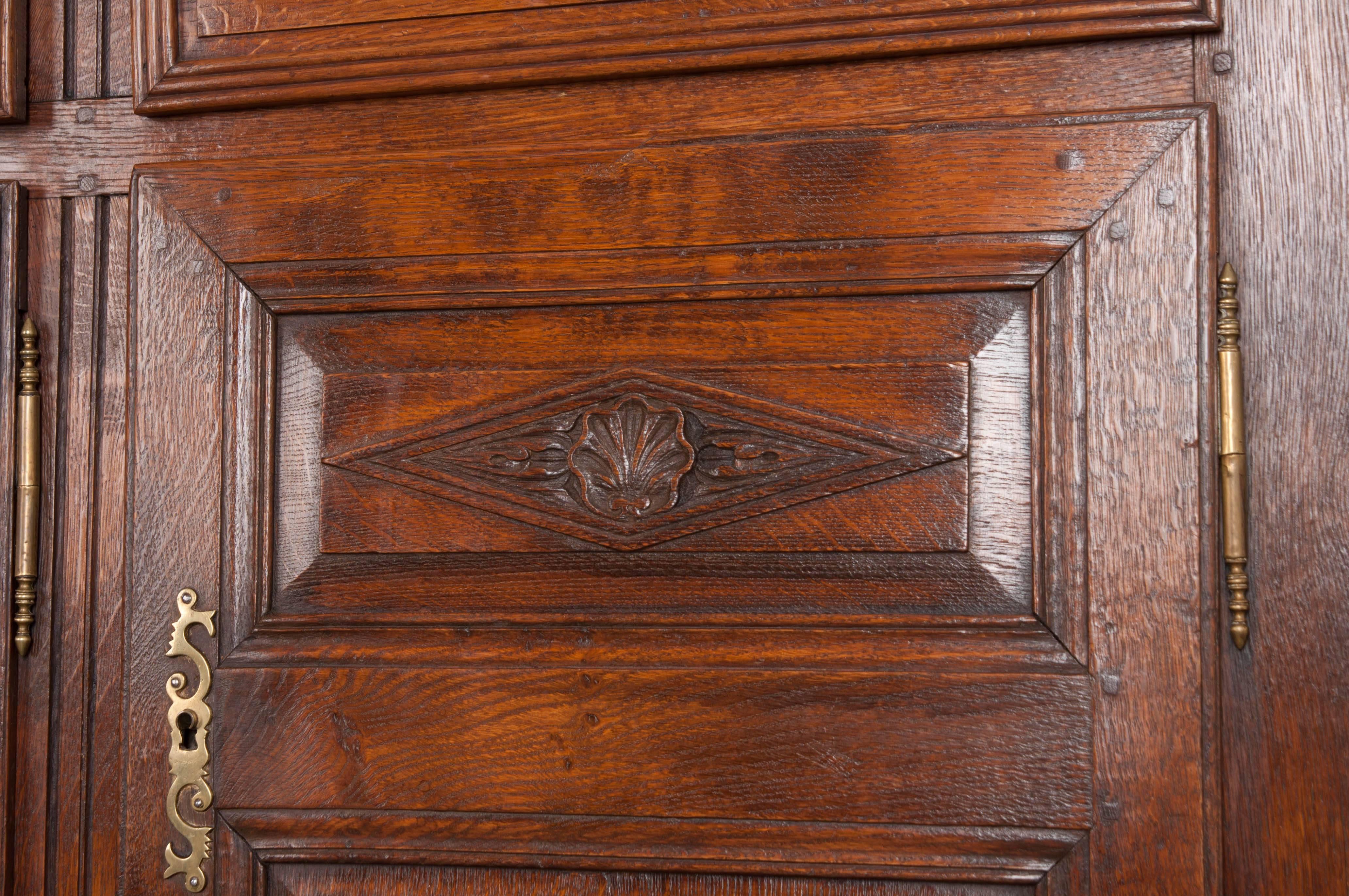 A large, French oak enfilade, made in Normandy towards the end of the 19th century. This tall piece has been made in the Provincial style. The antique contains three drawers that are set above three doors. The centre drawer is lockable, and all