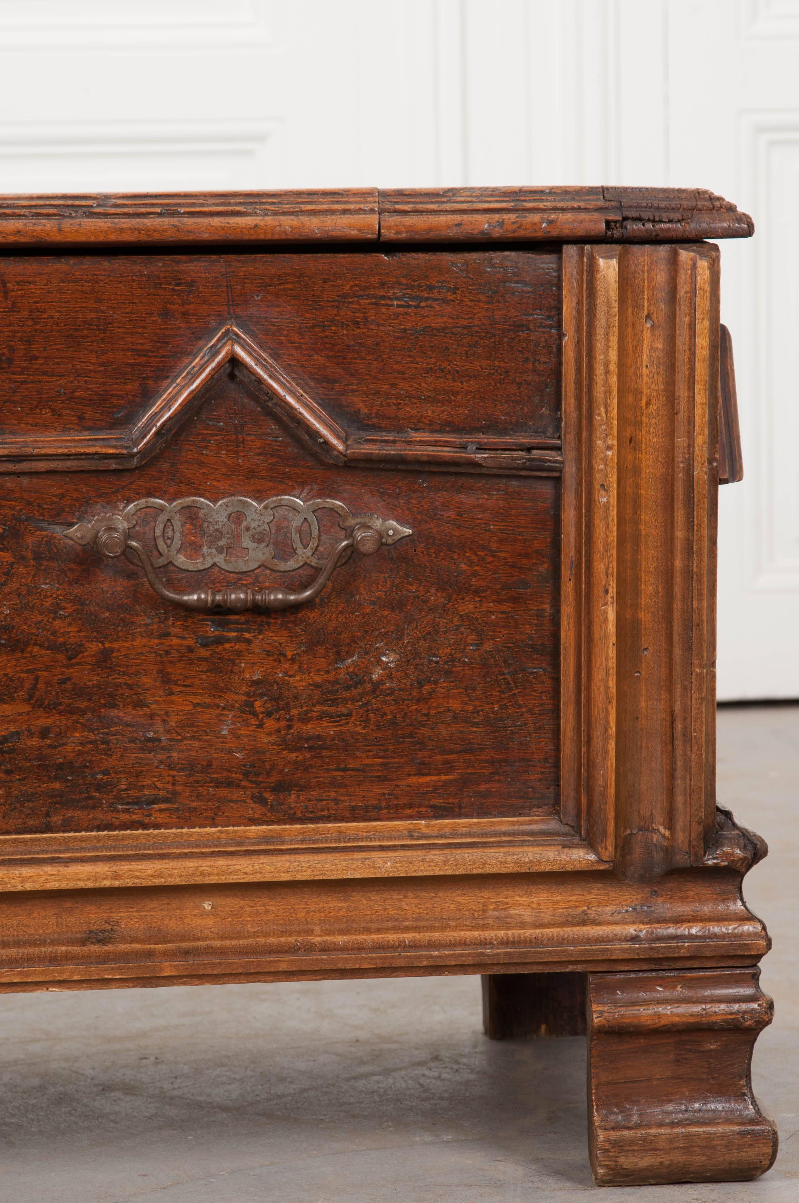 A stunning oak coffer from the early part of the 19th century, France. This wonderful trunk has a design reminiscent of Jacobean design, however is more recent. Beautiful moulded walnut trim frames the front and sides with other trim fashioned into