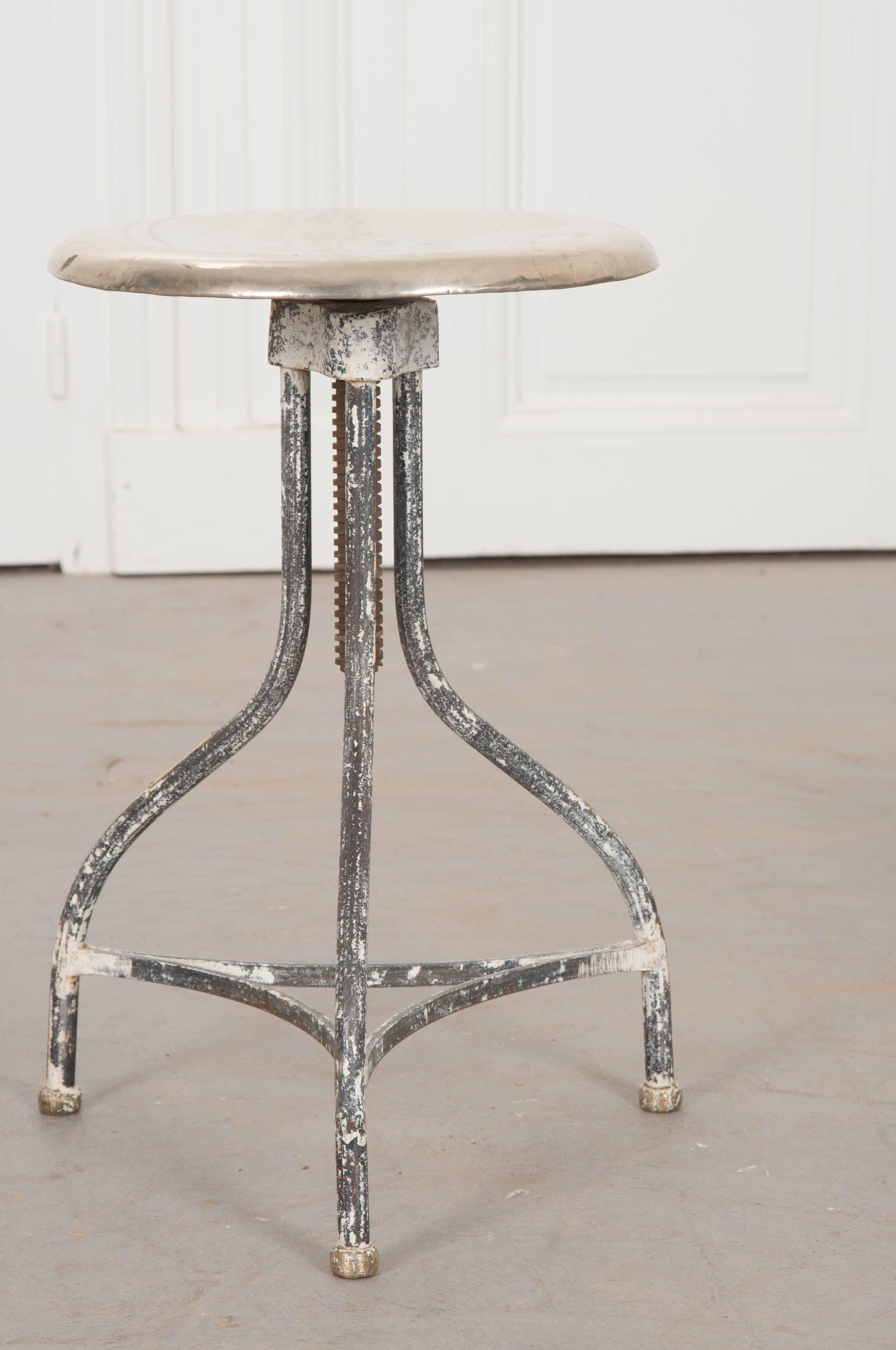 An exceptional stainless steel surgical stool, made in Belgium at the early part of the 20th century. The stool has an adjustable height, so you can elevate or lower the stool to suit your needs. The seat has a diameter of 12 1/2? and can have its