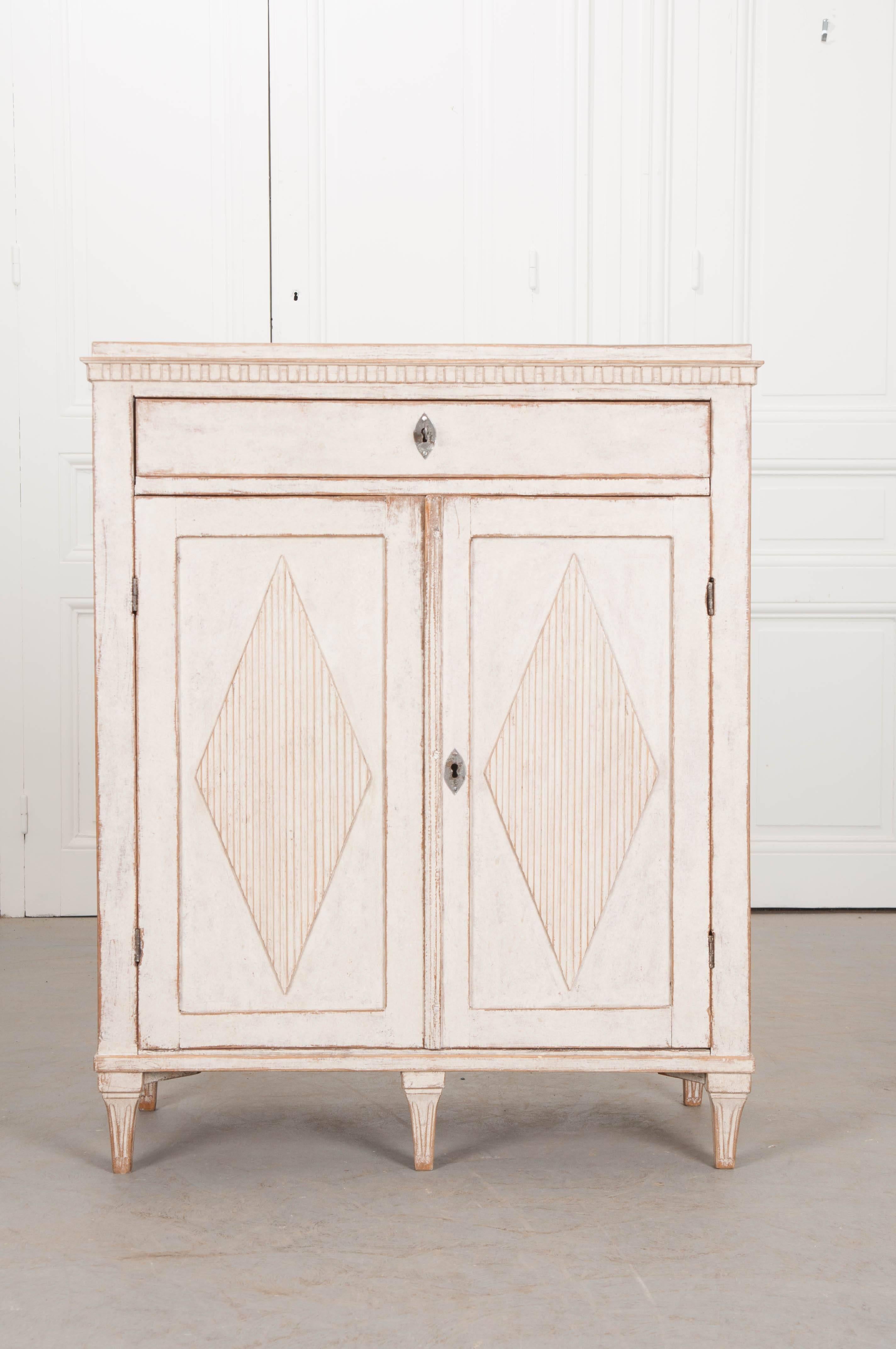 A remarkable Gustavian painted buffet, made in Sweden, towards the beginning of the 19th century. Painted a spectacular ivory-white, time has afforded the finish a patina that is simply stunning. Wonderful carved details also grace the buffet. The