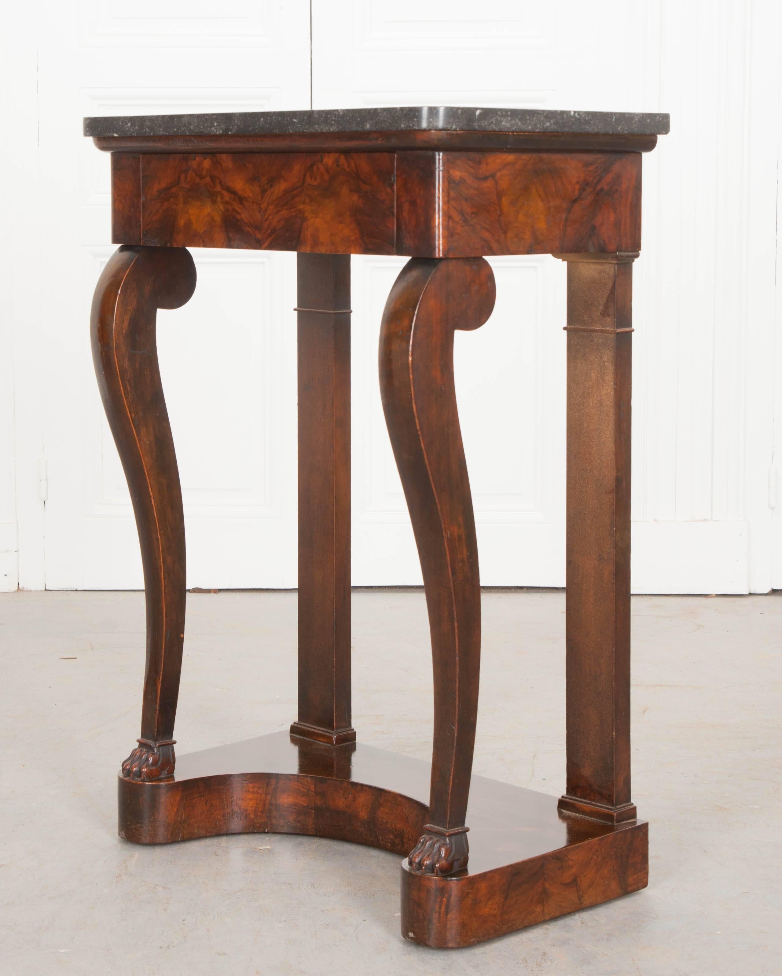 A stunning little marble-top console, Restauration period, France. The thick fossil-marble top is in wonderful antique condition, free from any noteworthy blemishes, and original to the console. The beautifully burled apron houses a drawer,