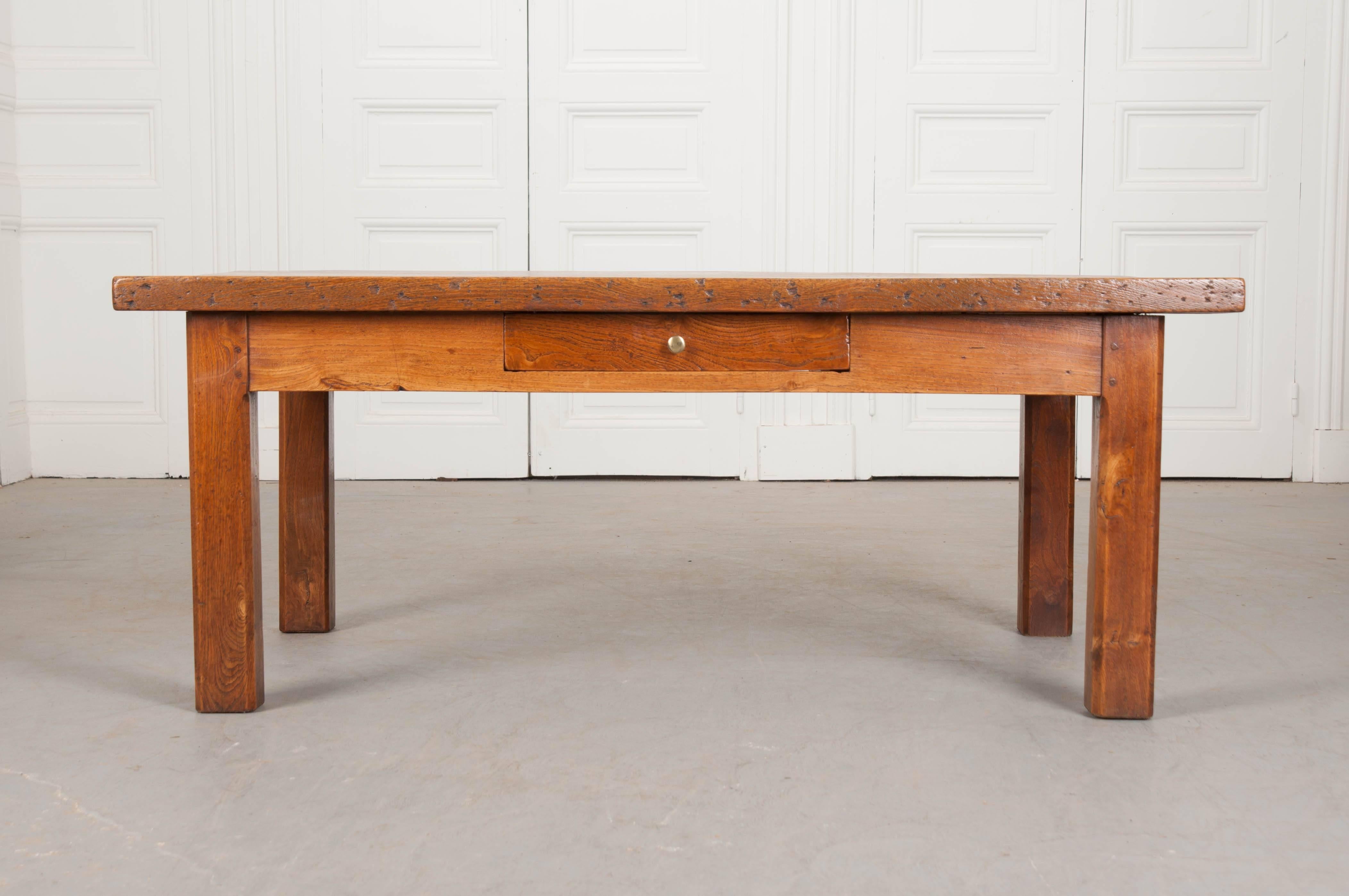 A French provincial chestnut coffee table from 19th century France. Two thick, solid chestnut boards comprise the top of this exceptional low table. These boards contain marvelous burl and grains that can be found throughout the tabletop. The