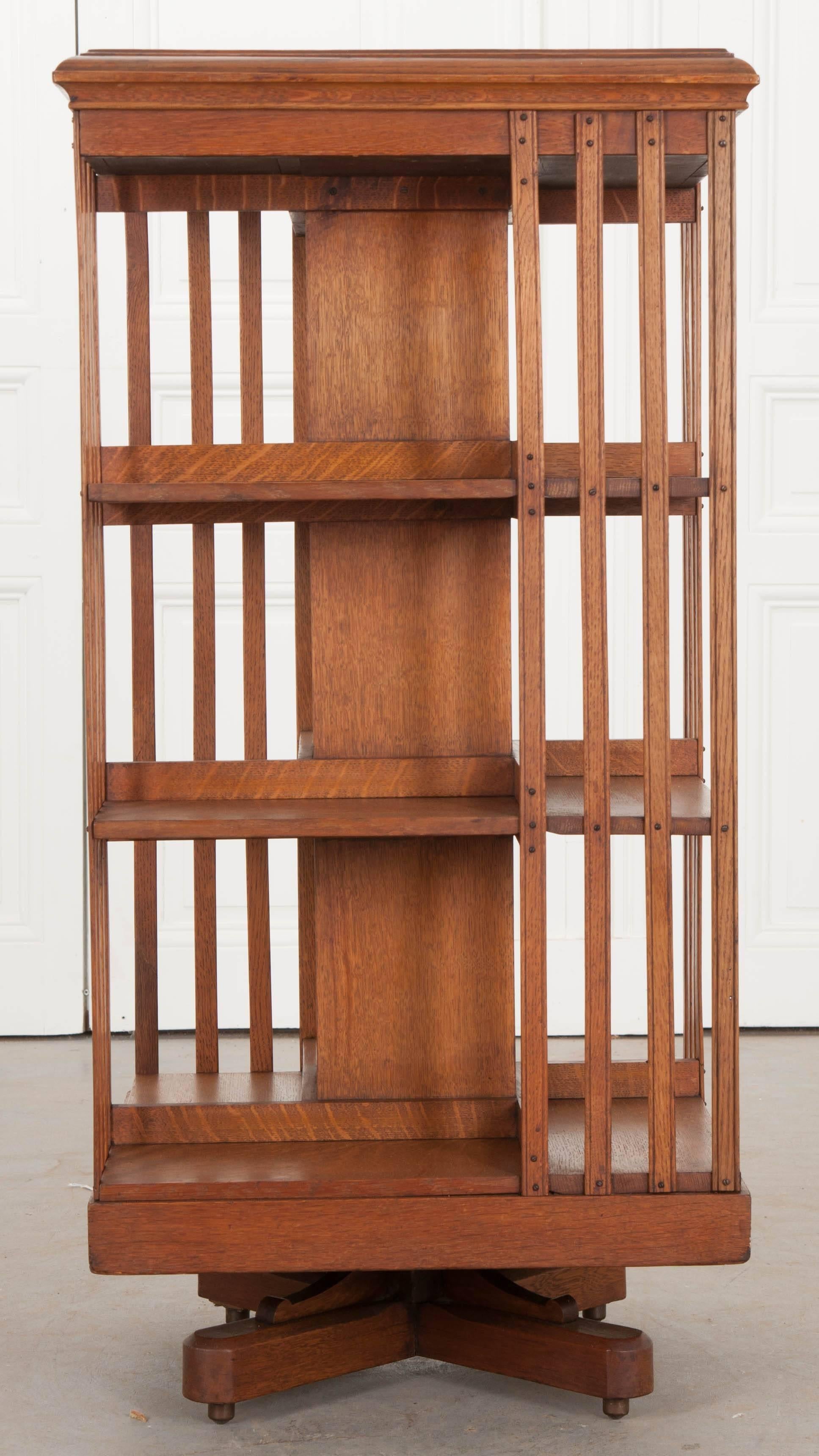 A fantastic and fun oak revolving bookcase, made in England, circa 1870. This bookcase was made by S & H Jewell, a quality, family-owned cabinet making company from west central London. The antique bookcase was made using solid quarter sawn oak. The