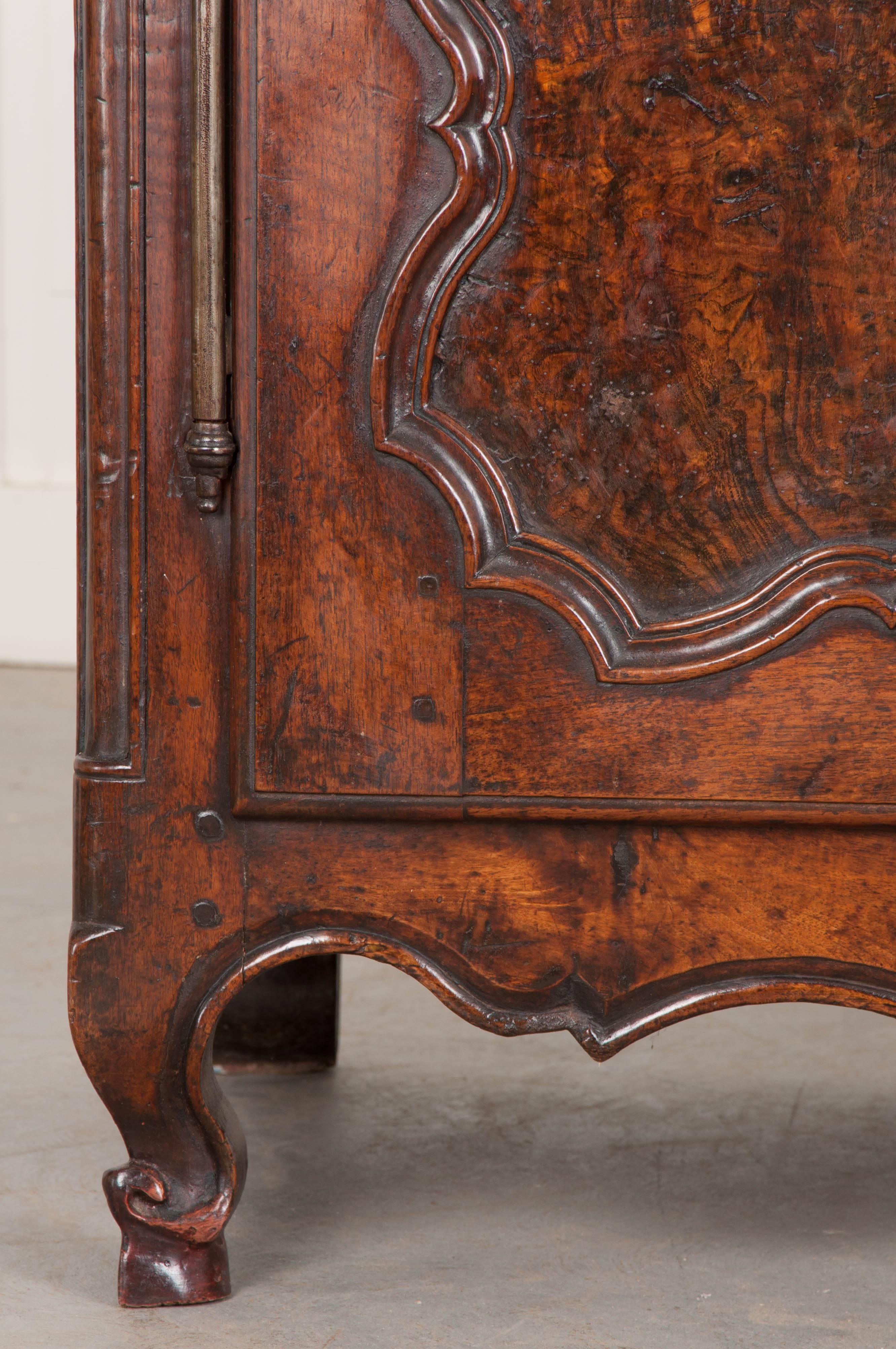 An amazing solid-walnut buffet, from 18th century France, with bountiful provincial charm and exceptional carved details. The top of the buffet is made of oak, which was also used modestly in the apron. It is rich in color, with beautiful grains.