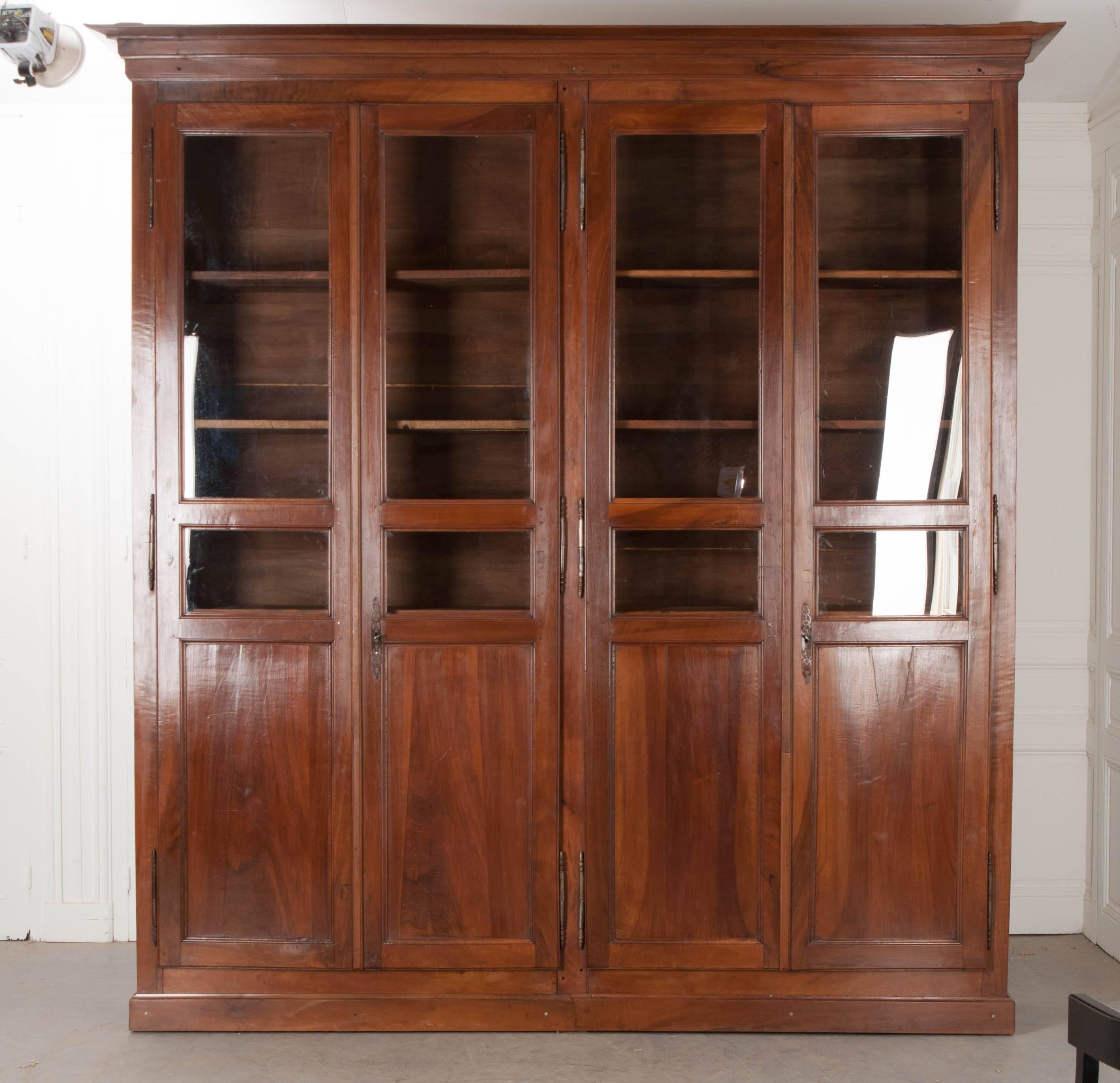 A stunning walnut bibliothèque from 19th century France. The four-door case piece has been made using carefully selected walnut boards, making for a uniform antique with no major color variation. The wood has a rich color and has aged magnificently.