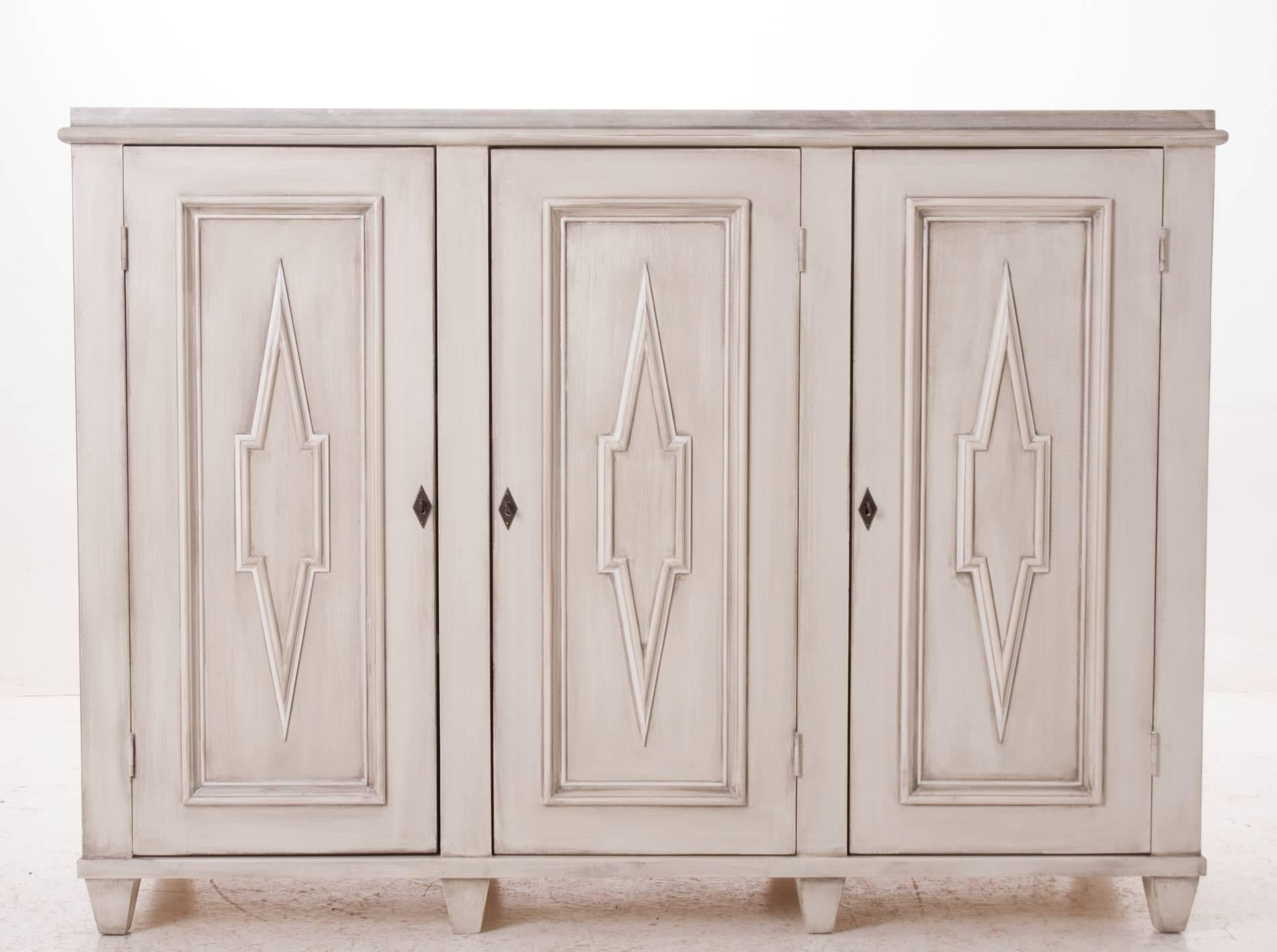 A fabulous example of a Swedish Gustavian buffet sideboard. This buffet has an impressive faux white marble top with a cream and gray wash for the base. Handcrafted paneling and designs give this buffet the look and the depth you will need for your