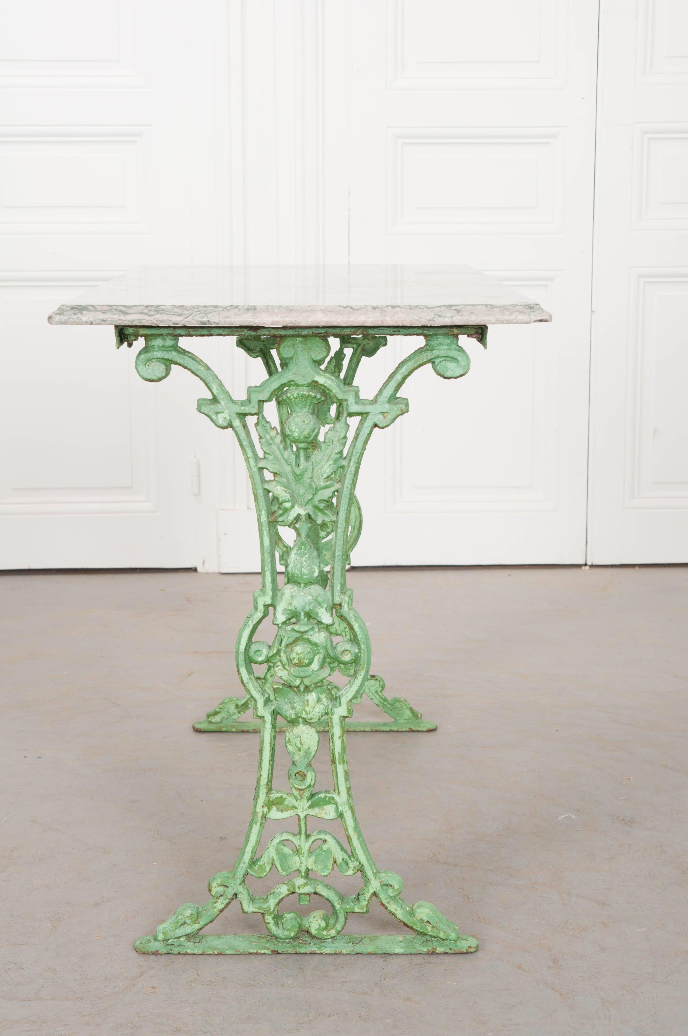 This gorgeous iron and marble bistro table comes from 19th century France. The marble top is in wonderful antique condition with unique and beautiful coloration. The top is supported by the table’s green-painted iron base. The green paint that coats