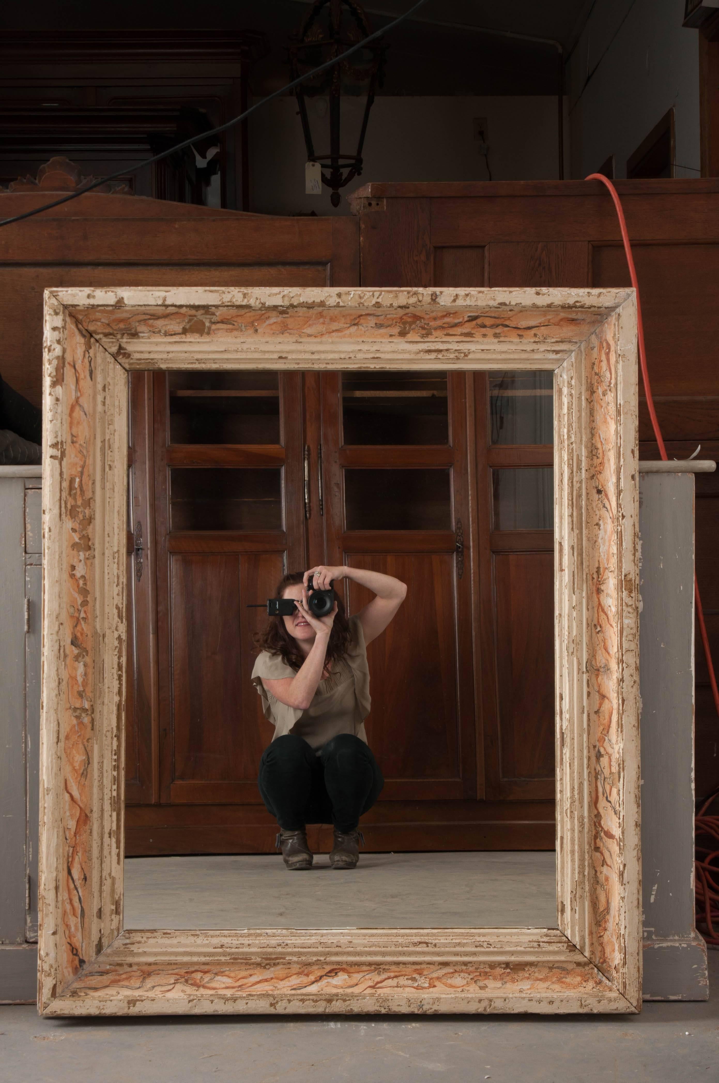 An exceptional antique Italian mirror with painted faux-marble surround. The mirror was made towards the middle of the 19th century and has a linear, moulded surround which has the wonderful painted faux-marble finish. The frame has been painted a