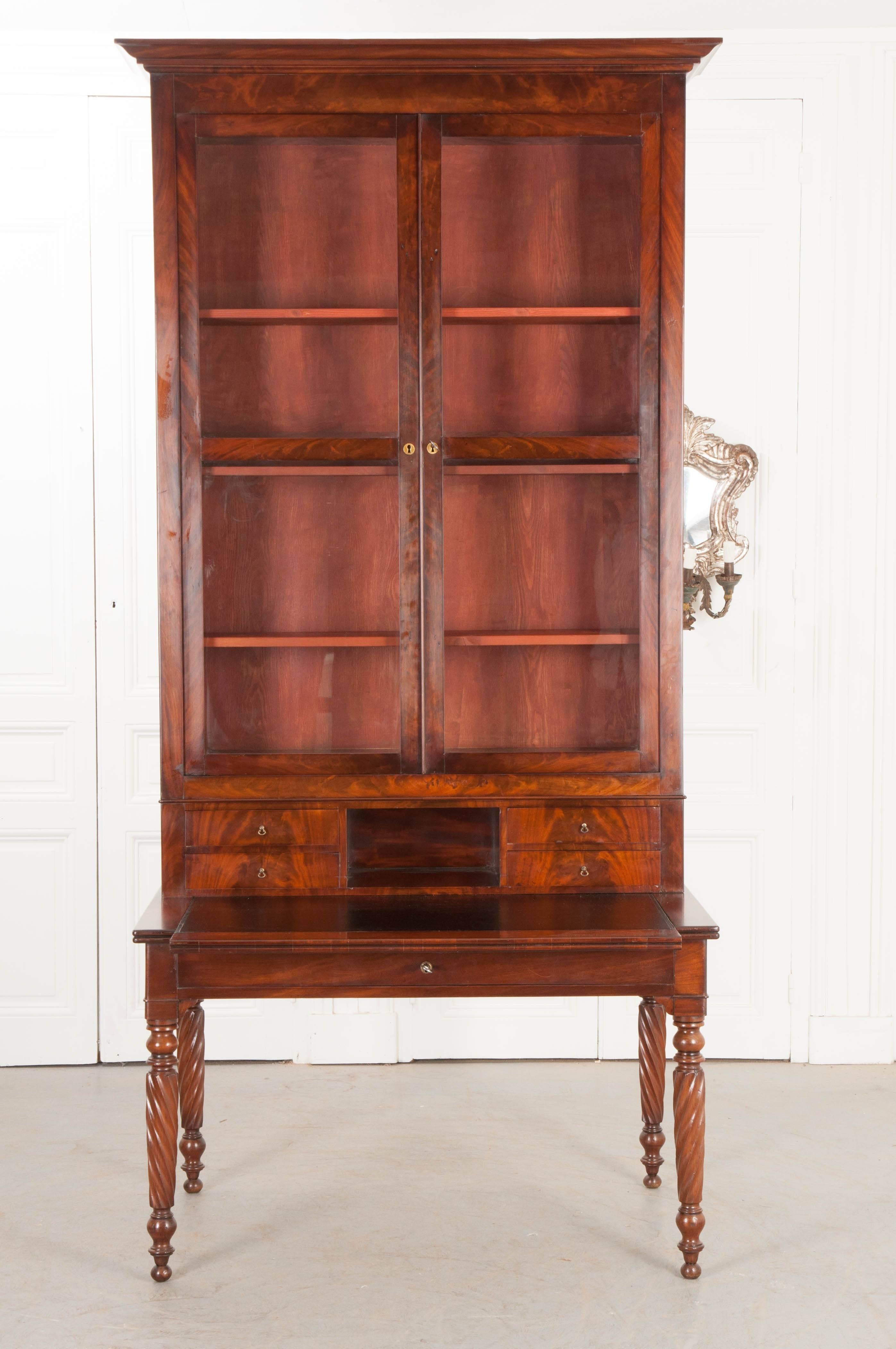 An exceptionally handsome mahogany secretary desk, made in France, circa 1810. The desk was made in the Regency style and is decked in exquisite mahogany veneer. The desk can be separated into two bodies: the lower writing surface, and the upper