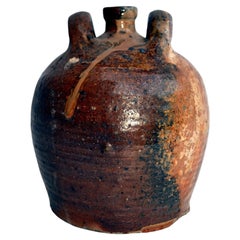 Antique stoneware jug with glazed enamel drips