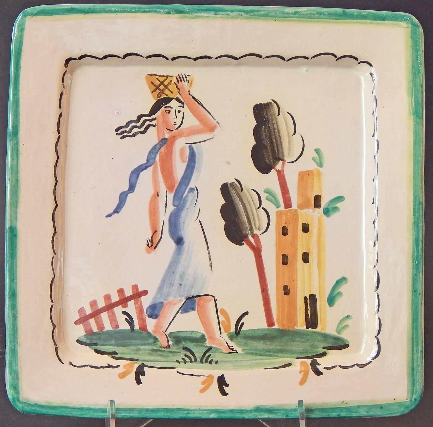 Painted with freshness and sophistication, this pair of Italian Art Deco plates depict elegant female figures, each balancing baskets on their heads, striding toward a tower in the distance.  One in a blue Classical robe, with her Art Deco hair