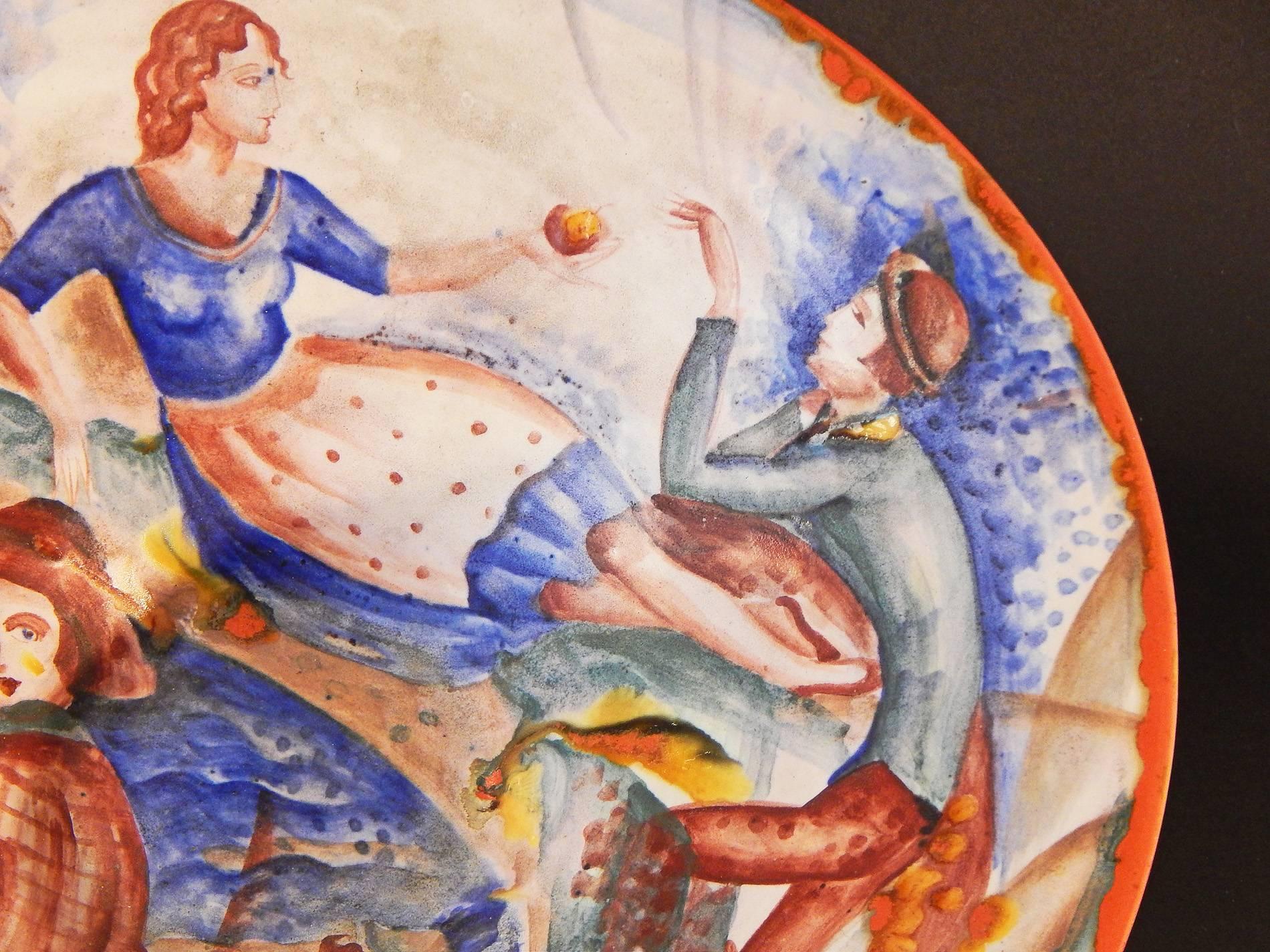 Whimsical and vividly glazed, this fabulous, unique Art Deco bowl depicts two contrasting scenes from a rural seaside village: a father and son fishing at the shore, and a young woman and man, the former offering a piece of fruit to the latter like