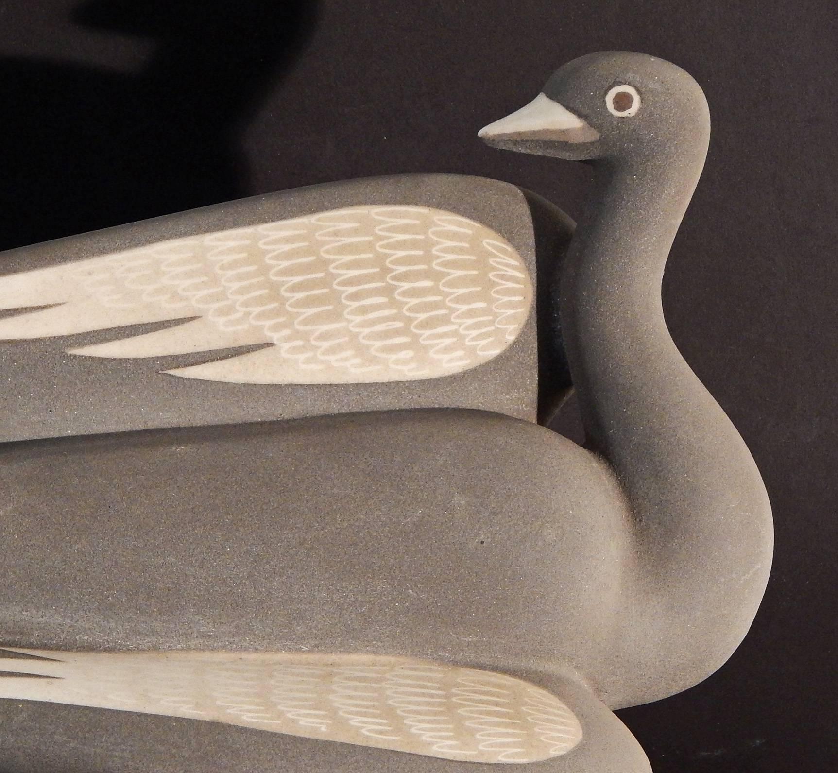 One of Waylande Gregory's most dynamic and winning sculptures, this example glazed in a velvety grey flannel color, the swan is shown from two sides, with its lovely taupe wings on full display. Like most of his animal sculptures, this one displays
