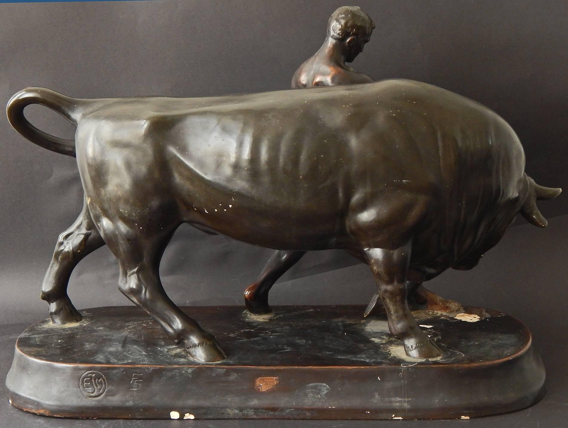A rare, perhaps unique sculpture, well-marked with the monograms of the sculptor and ceramic works and the label of the original retailer in Germany, this piece depicts a nude male youth leading a bull, one hand on the leather lead and another on