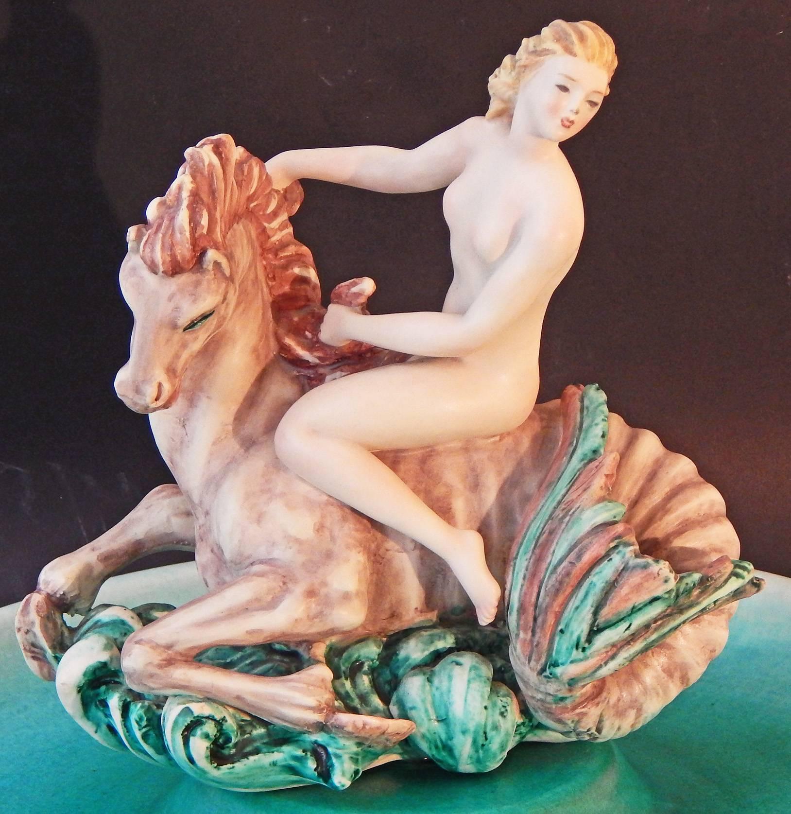 Charming and exquisite, this unique centerpiece -- sculpted, not molded -- depicts a nude female figure riding a mythological hippocampus -- half horse, half fish -- at the center of a shallow bowl the color of the sea. This piece was crafted in