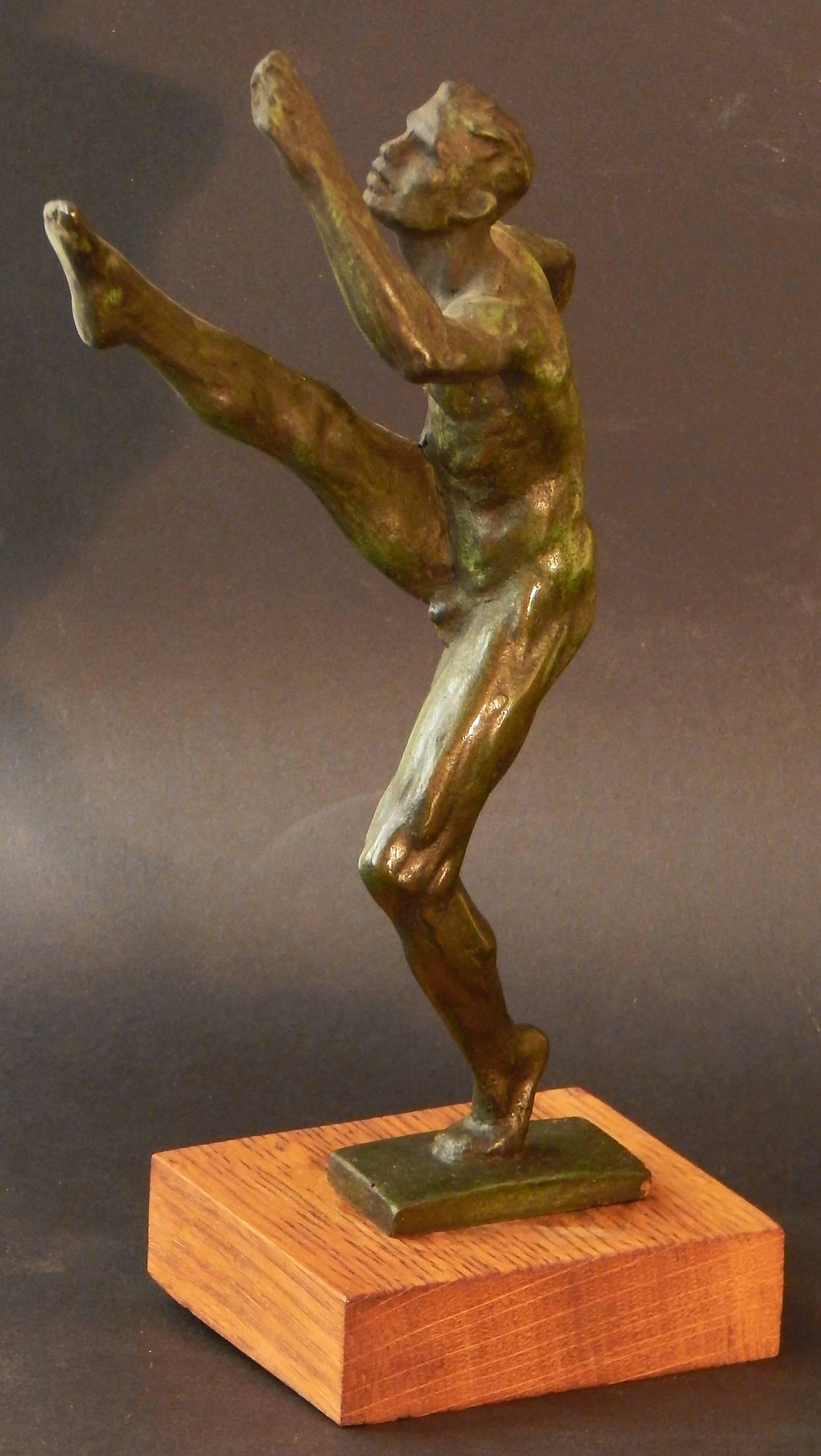 Sculpted in bronze by Joe Brown, second in a line of great American sculptors of athletes in motion, this famous depiction of a football punter dates to the 1940s. Brown studied under, and was mentored by, Robert Tait McKenzie, a physician, educator